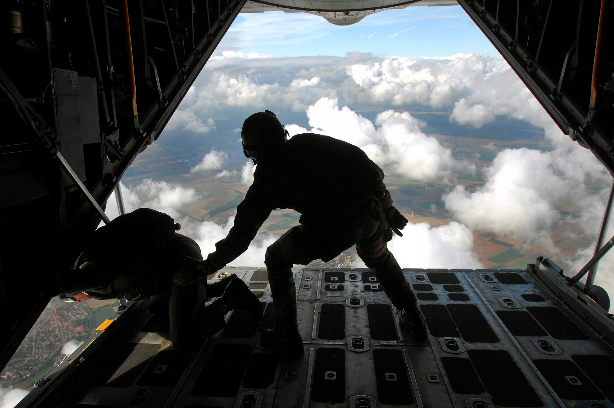 United States Air Force pararescuemen survey the skyline before performing a HALO over Southwestern Germany, Sept. 24, 2008. Both pararescuemen jumped in conjunction with the 786th Security Forces Squadron during jump training. (U.S. Air Force photo by Airman 1st Class Kenny Holston)(Released)