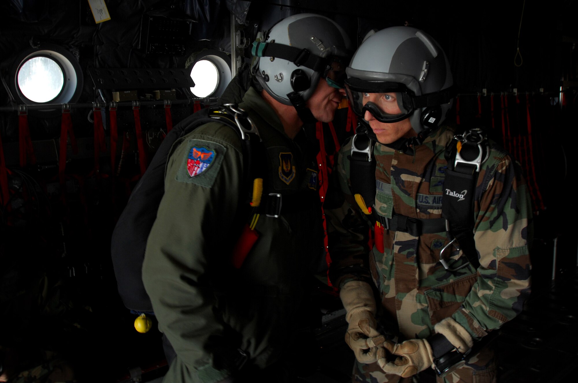 United States Air Force pararescuemen perform a final equipment check before going airborne out the back of a C-130 Hercules over Southwestern Germany, Sept. 24, 2008. Both pararescuemen jumped in conjunction with the 786th Security Forces Squadron during jump training. (U.S. Air Force photo by Airman 1st Class Kenny Holston)(Released)