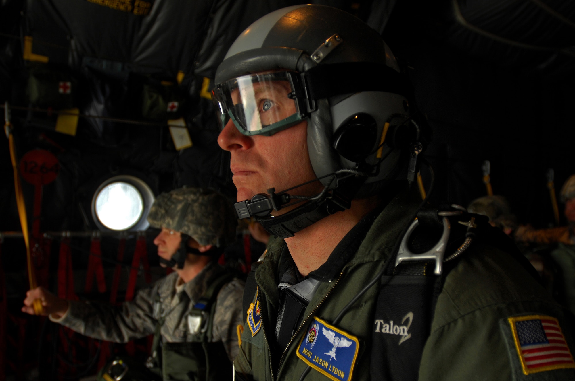A United States Air Force pararescueman looks out the back of a C-130 Hercules before executing a jump over Southwestern Germany, Sept. 24, 2008. The pararescueman jumped in conjunction with the 786th Security Forces Squadron during jump training. (U.S. Air Force photo by Airman 1st Class Kenny Holston)(Released)  