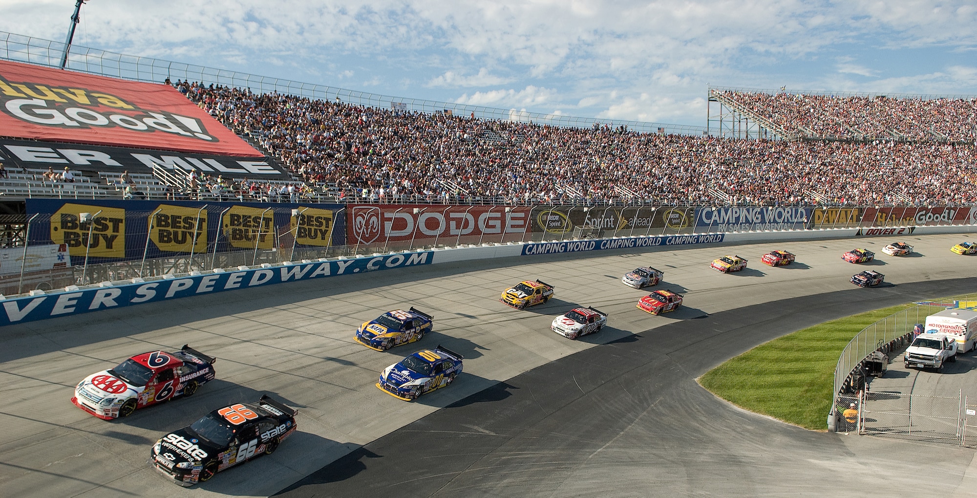 DOVER, Del. -- Several stock cars, including the No. 21 Air Force car, race around the Monster Mile Sunday. Twice a year NASCAR races at Dover Downs and servicemembers from all over Delaware participate in the festivities. Besides providing a flyover Sept. 19, Dover Airmen served food, provided security and presented the colors during several events on 'race weekend.' (U.S. Air Force photo/Jason Minto) 