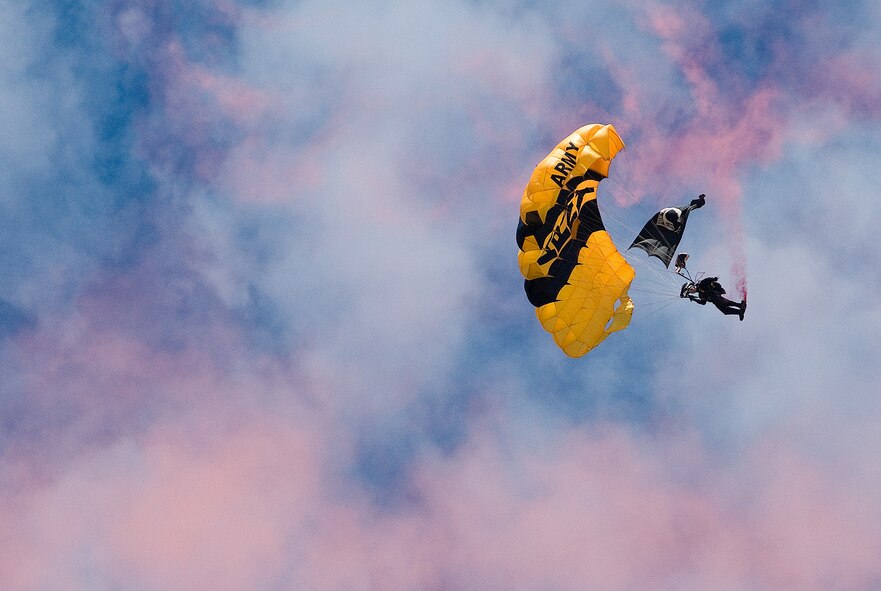 DOVER, Del. -- A member of the Army-s Golden Knights parachute team glides down to the track at Dover Downs Sunday during prerace ceremonies. The race was a joint service event with a performance from the Golden Knights, a flyover from two Navy F-18 Super Hornets and greeting from Air Force Maj. Gen. Irving Halter Jr., vice director, Operations, Joint Staff, the Pentagon, Washington, D.C. (U.S. Air Force photo/Roland Balik) 