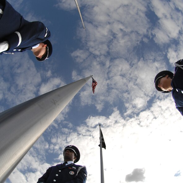 Base Honor Guard members stand ready to participate in the POW/ MIA ceremony here Sept. 19. The ceremony included a speech from Dr. Frederick Kiley, co-author of Honor Bound, a book about prisoners of war in Southeast Asia. (U.S. Air Force Photo by Airman 1st Class Rae Henline)