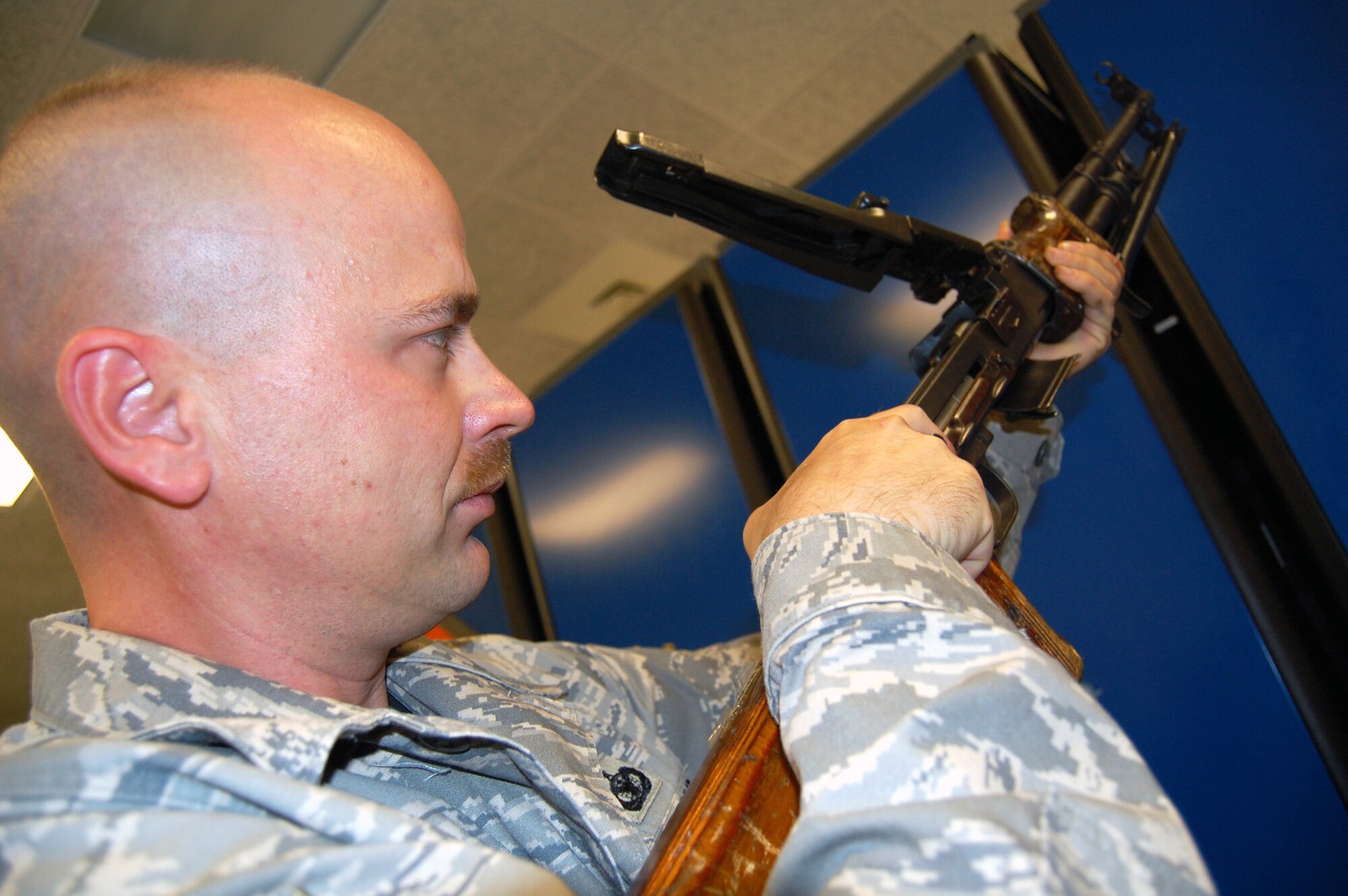 Tech. Sgt. Charles Glunt, U.S. Air Force Expeditionary Center armory noncommissioned officer in charge, inspects the forward assembly of a machine gun while working in the armory on Fort Dix, N.J., Sept. 22, 2008.  Sergeant Heraty and three other Airmen manage 48 different weapons systems and 153 different types of foreign weapons in the USAF EC armory -- the most foreign weapons than any armory in the Air Force.  The weapons they care for support more than 7,000 students annually who attend the center's expeditionary courses. (U.S. Air Force Photo/Tech. Sgt. Scott T. Sturkol)