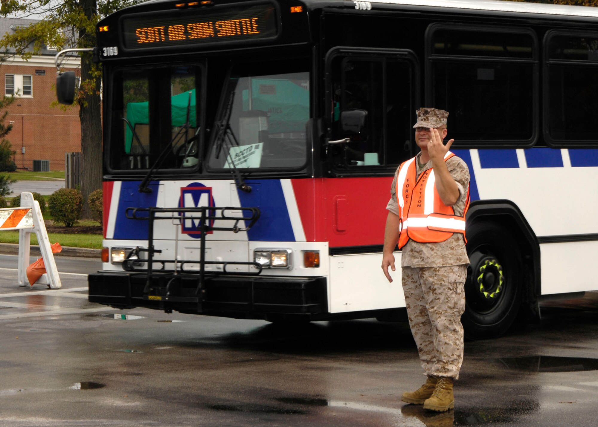 SCOTT AIR FORCE BASE, Ill. -- 
Marine Corps Master Sgt. Michael Fincher, U.S.TRANSCOM force protection, directs traffic during the Airpower Over the Midwest airshow. Controlling the flow and direction of traffic was a vital factor in maintaining security and accountability for both visitors and employees at Scott.
(US Air Force photo/Senior Airman Jonathan Lovelady)
 
