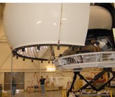 DOVER AIR FORCE BASE, Del. -- Flight Safety International Visual System Support Team members lift a mirror that will be part of Dover’s C-17 Globemaster III simulator Sept. 10. The mirror is vacuum sealed Mylar made in England and makes everything pilots see look 3-D. The simulator is due to be complete in December. (U.S. Air Force photo/Senior Airman James Bolinger)