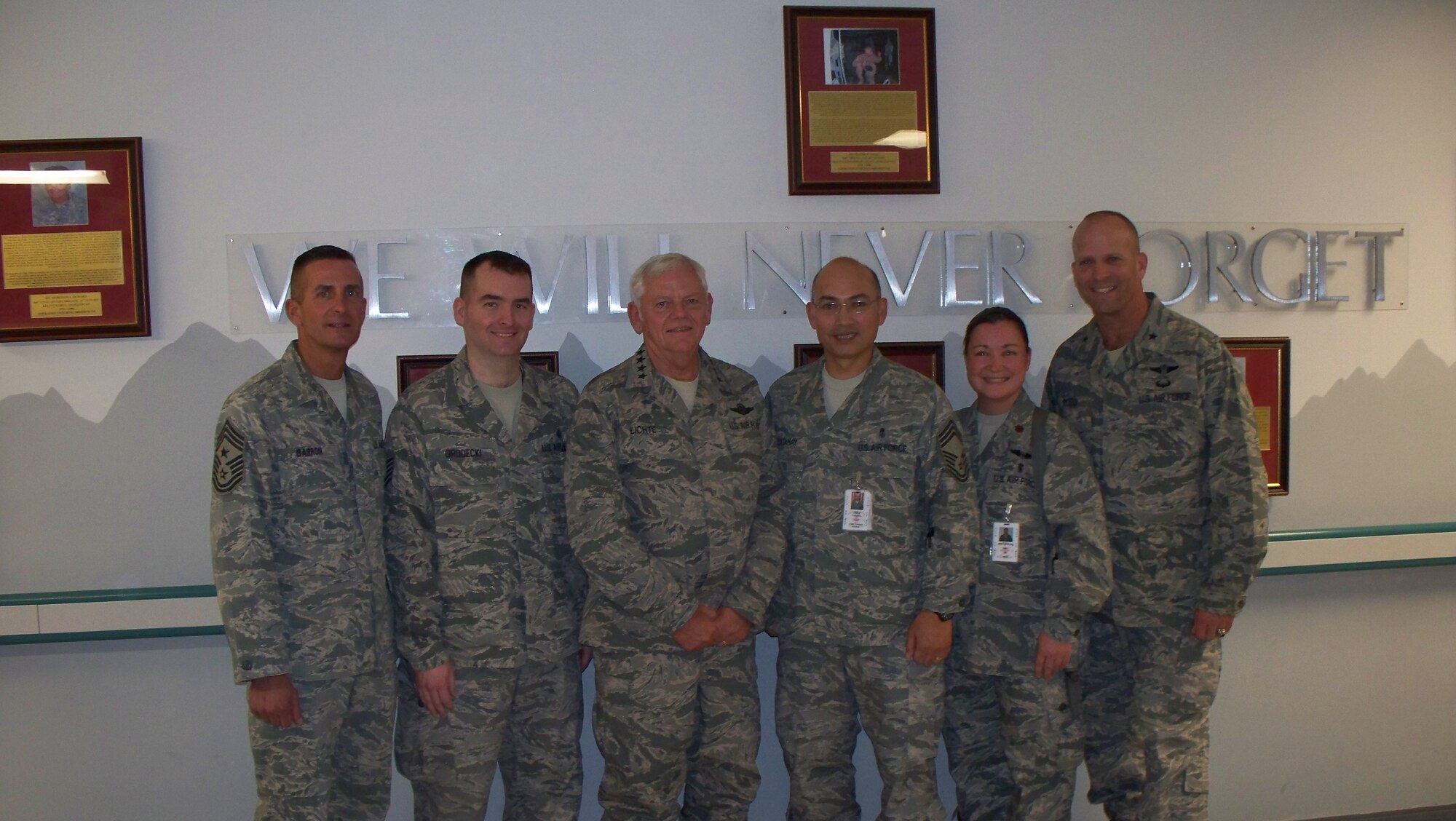 SCOTT AIR FORCE BASE, Ill. --Chief Master Sgt. Joseph Barron, Air Mobility Command command chief, Tech. Sgt. Russell Grodecki, AMC headquarters Mission Capability Reporting and Analysis NCOIC, Gen. Arthur Lichte, AMC commander, Chief Master Sgt. Richard Catahay, AMC headquarters command aerospace medical service functional manager, Maj. Tammy Pokorney, Homeland Security Plans and Programs chief and Brig. Gen. Douglas Robb, AMC command surgeon stand in front of the Craig Joint Theater Hospital Remembrance Wall in Bagram Air Field, Afghanistan during General Lichte’s visit to the Area of Responsibility to observe the impact of the AMC. 
Courtesy photo