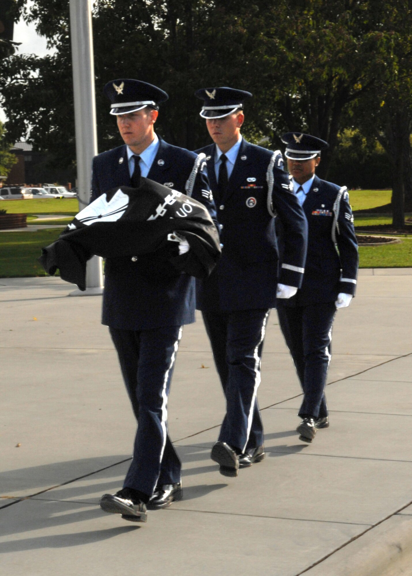 Members of the base Honor Guard march the POW/MIA flag to the stage to fold it for the POW/ MIA ceremony here on Seymour Johnson Air Force Base, Sep. 19, 2008. The ceremony included a speech from Dr. Frederick Kiley, author of Honor Bound, a Pulitzer Prize nominated book about prisoners of war in Southeast Asia. (U.S. Air Force Photo by Airman 1st Class Rae Henline)