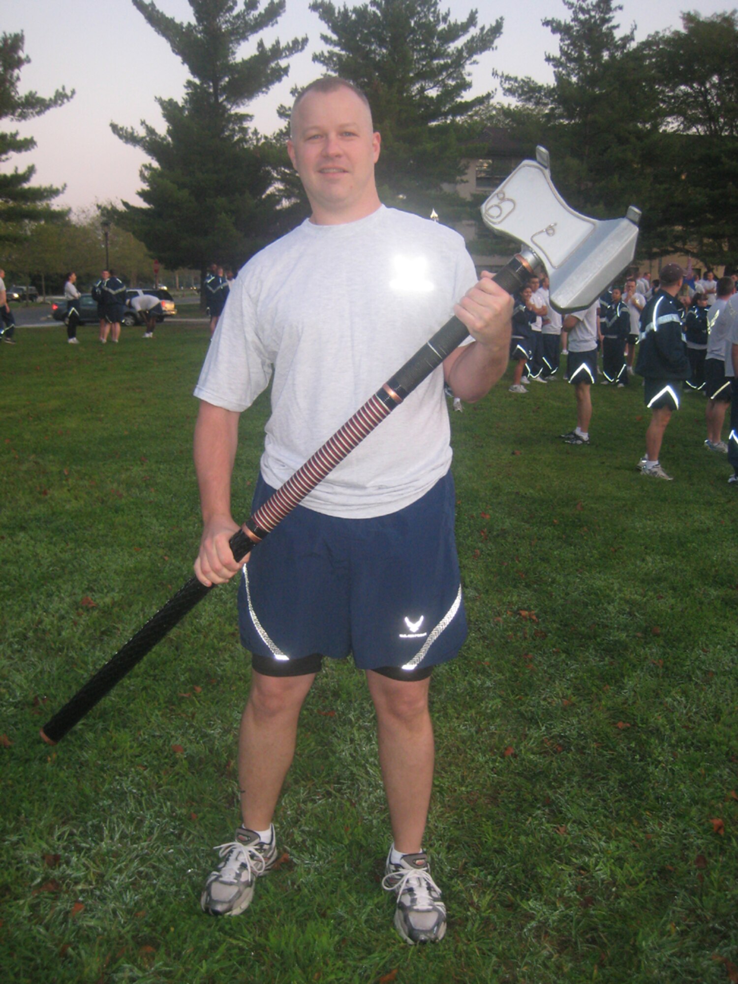 Tech Sgt. Jery Dail hoists the 78-lbs "War Hammer" of the 305th Logistics Readiness Squadron before the Warrior Run, Sept 24. The 305th LRS ran with the hammer the entire length of the course. The day started off with the run at 7 a.m. followed by several other events, including basketball, walleyball and a bench-press competition. (U.S. Air Force photo/1Lt Dustin Doyle)                             