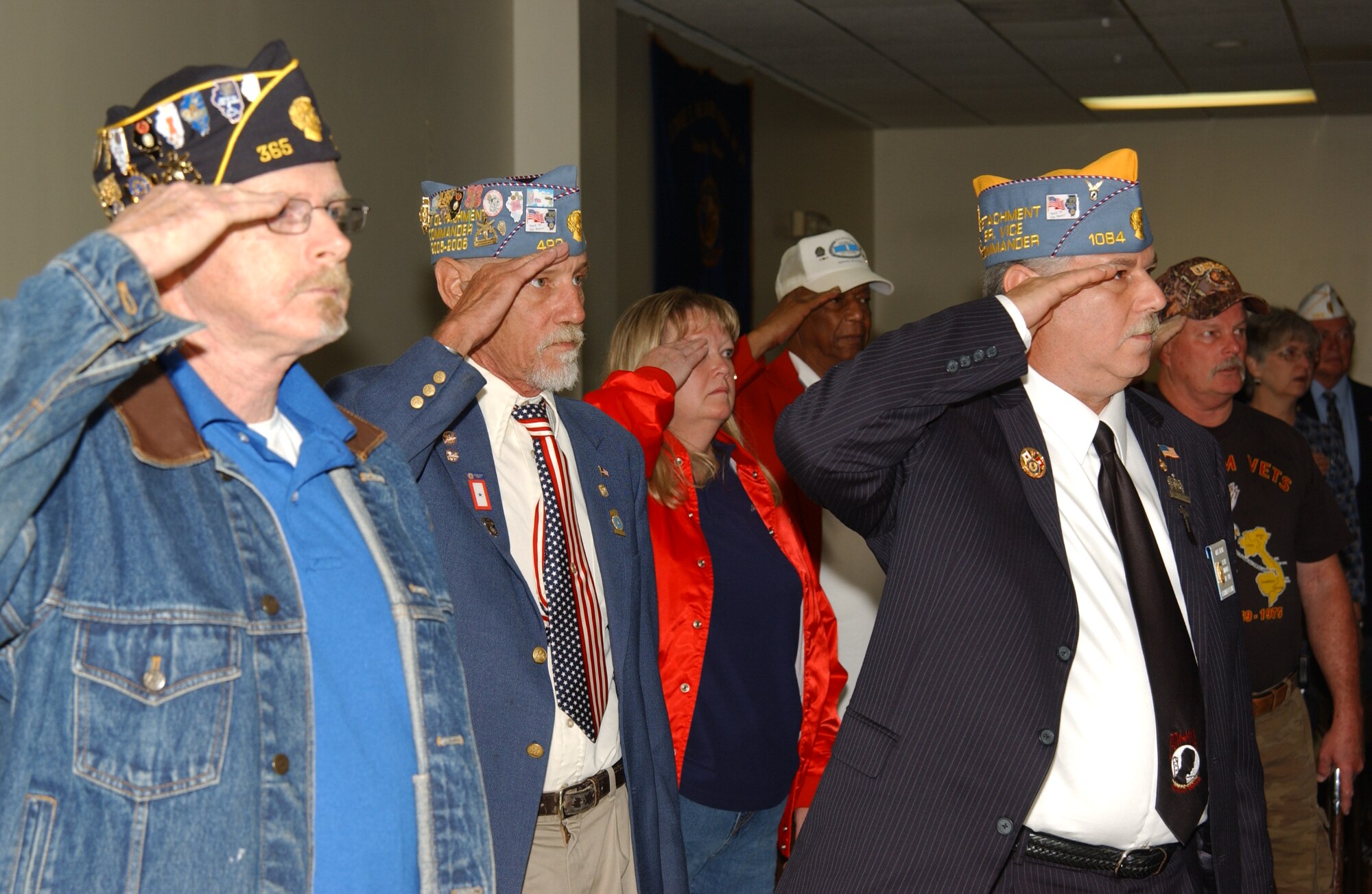 SCOTT AIR FORCE BASE, Ill. -- Veterans, former prisoners or war and current servicemembers salute as the Korean War Veterans Association post the colors at the 17th annual Prisoner of War/Missing in Action Recognition Ceremony hosted by the Scott POW/MIA Council Saturday at Freedom Farm in Freeburg, Ill. Several people gathered to honor servicemembers currently at war and those who did not return. After the ceremony, participants were invited to a barbeque. 
(US Air Force photo/Airman 1st Class Amber Kelly-Woodward) 
