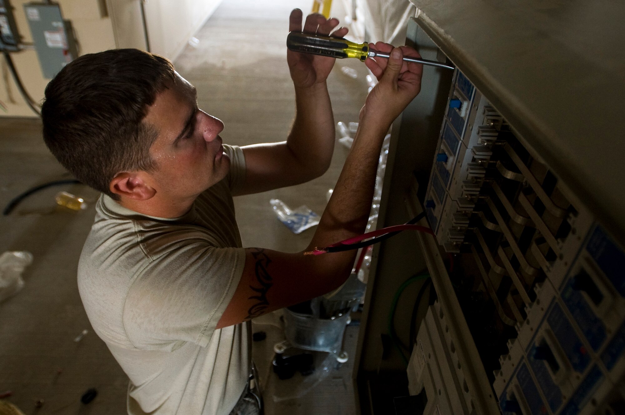 ALI BASE, Iraq -- Senior Airman Curtis Barnhill, 407th Expeditionary Civil Engineer Squadron electrician, connects cables to the power supply Sept. 24, 2008. With the relocation of the force protection facility, Airmen in the 407th ECES Power Pro shop are installing a new power supply and light fixtures. Barnhill is deployed from F.E. Warren Air Force Base, Wyo. (U.S. Air Force photo/Airman 1st Class Christopher Griffin)
