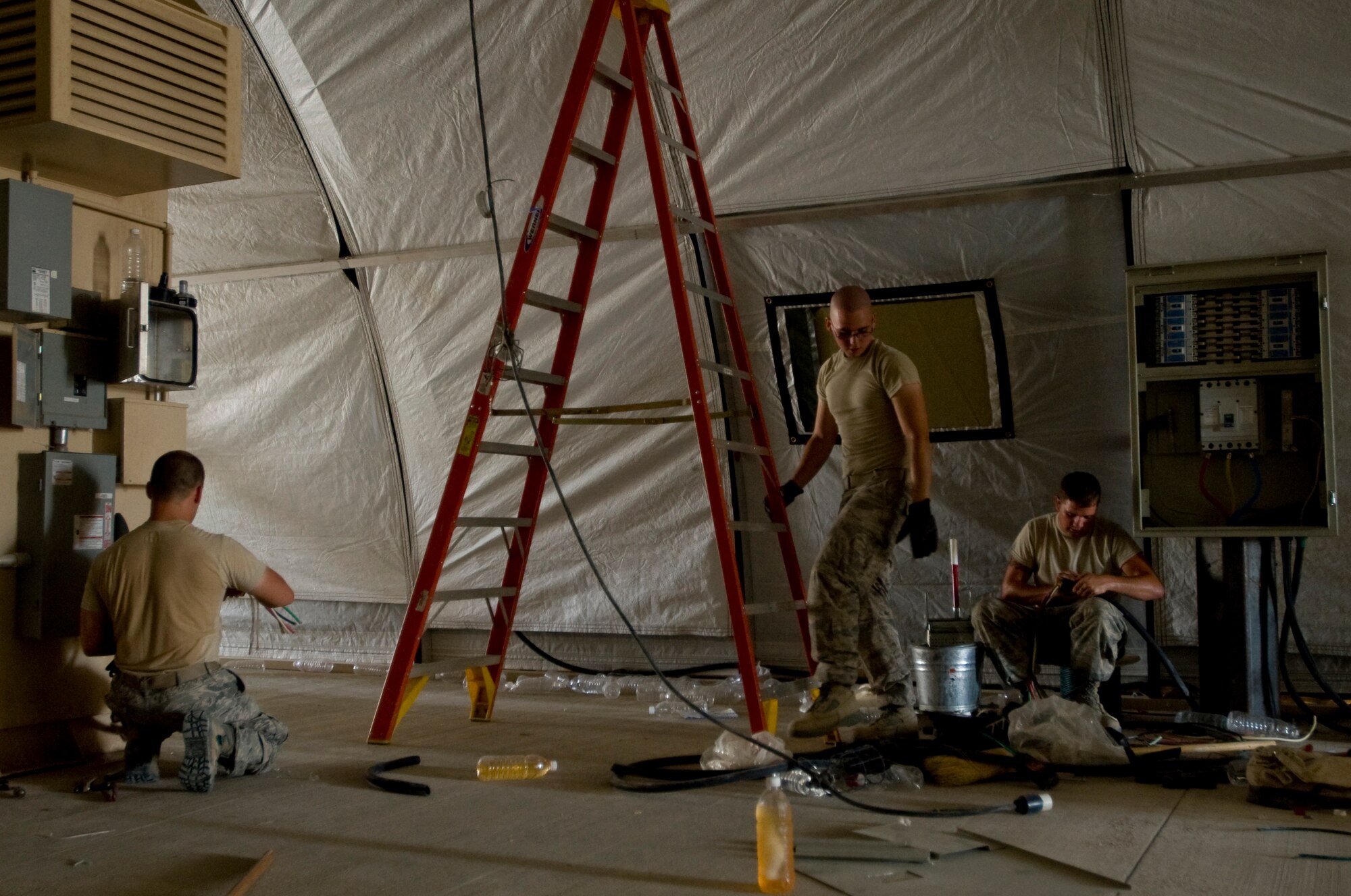 ALI BASE, Iraq -- Airmen of the 407th Expeditionary Civil Engineer Squadron Power Pro shop prepare the new force protection facility for use Sept. 24, 2008. With the relocation of the force protection facility, they installed new power supply and light fixtures. (U.S. Air Force photo/Airman 1st Class Christopher Griffin)