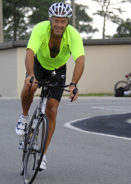 A competitor in the sprint triathlon held on Seymour Johnson Air Force Base, N.C., begins the biking portion, Sep. 20.The triathlon consisted of a 400 meter swim, a 15 mile bike ride, and a four mile run. (U.S. Air Force photo by Airman 1st Class Makenzie Lang)