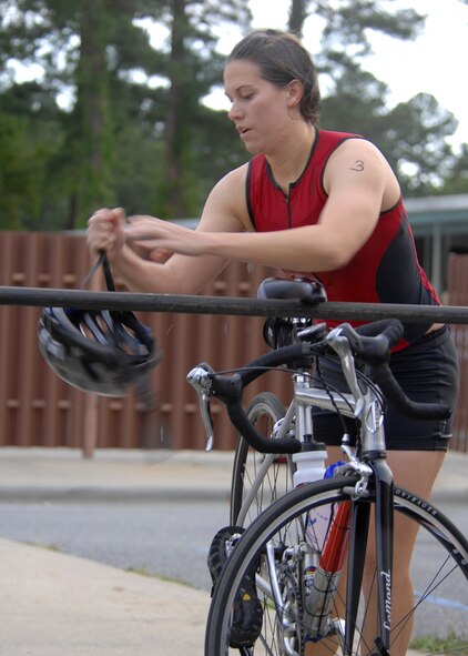 Second Lieutenant Lindsey Kirschhoff quickly transitions from the swimming portion to the biking portion of the Sprint Triathlon held on Seymour Johnson Air Force Base, N.C., Sep. 20.  Lieutenant Kirschhoff was the first swimmer to complete the 400 meter swim. (U.S. Air Force photo by Airman 1st Class Makenzie Lang) 