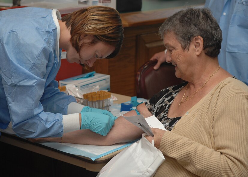 An Airman from the 4th Medical Group takes a blood sample from a volunteer worker at Retiree Appreciation Day on Seymour Johnson Air Force Base, N.C., Sep. 20. The 4th MDG set up stations with free healthcare information for the retirees. ( U.S. Air Force Photo by Airman 1st Class Makenzie Lang) 
