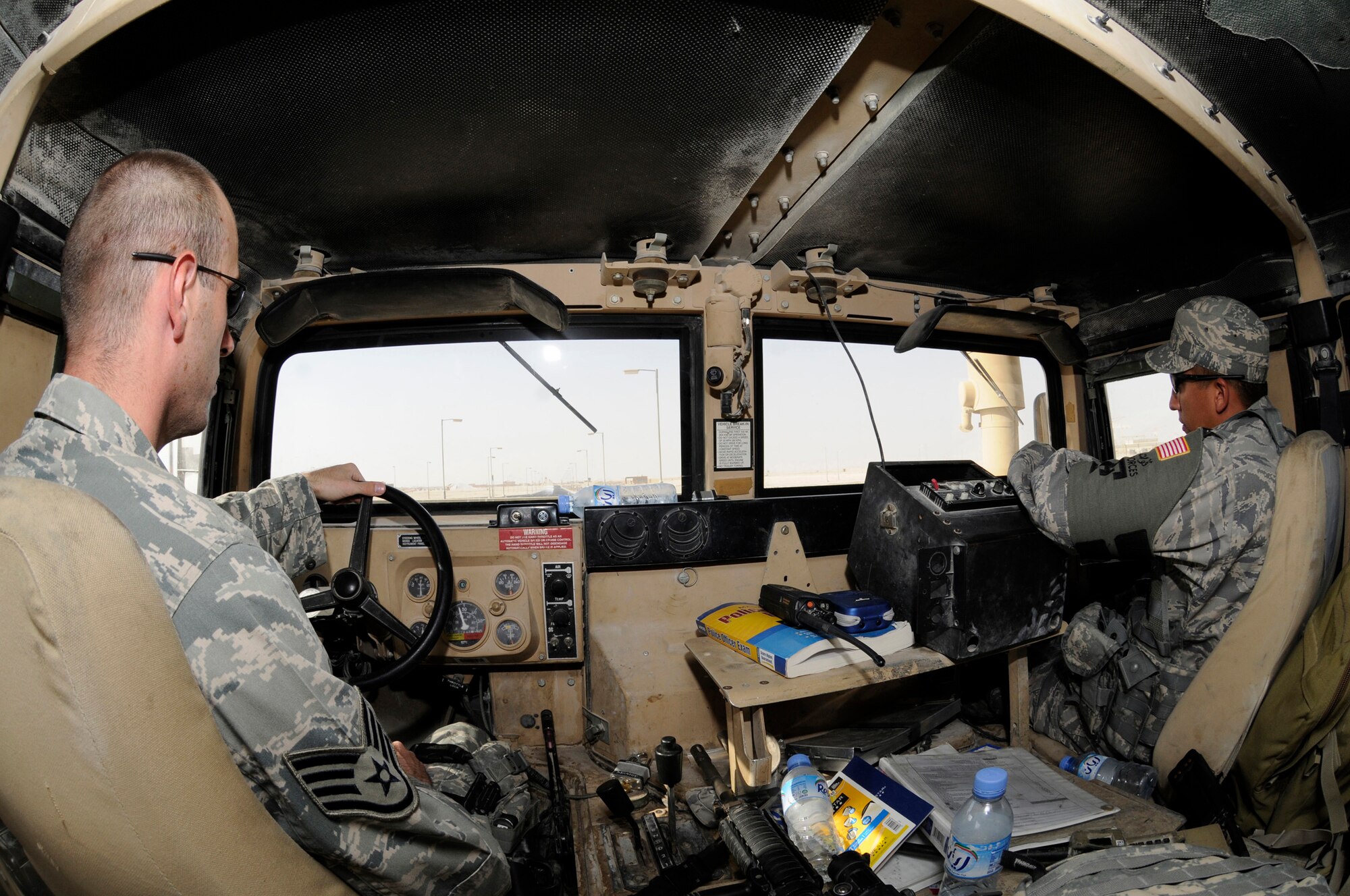 Senior Airman Michael Renteria and Staff Sgt. Benjamin Thomas, patrolmen assigned to the 379th Expeditionary Security Forces Squadron, patrol their assigned route Sept. 24, 2008, at an undisclosed air base in Southwest Asia. Patrolmen assigned to the ESFS ensure the safety and security of resources and personnel assigned here supporting Operations Iraqi Freedom, Enduring Freedom and Joint Task Force-Horn of Africa. Sergeant Thomas, a native of Mehoopany, Pa., is deployed from Keesler Air Force Base, Miss., and Airman Renteria, a native of Deming, N.M., is deployed from Schriever AFB, Colo. (U.S. Air Force photo by Staff Sgt. Darnell T. Cannady/Released)