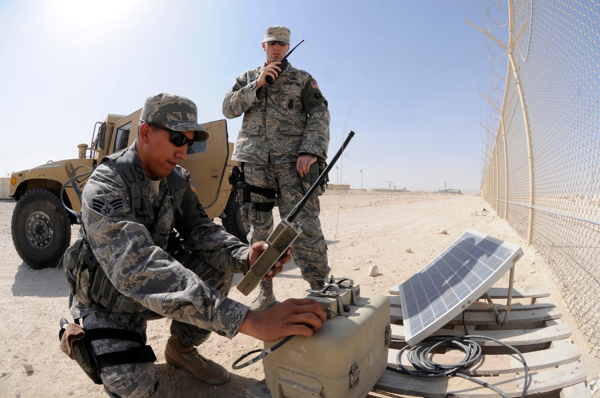 Senior Airman Michael Renteria and Staff Sgt. Benjamin Thomas, patrolmen assigned to the 379th Expeditionary Security Forces Squadron, verify an alarm system is working properly Sept. 24, 2008, at an undisclosed air base in Southwest Asia. Patrolmen assigned to the ESFS ensure the safety and security of resources and personnel assigned here supporting Operations Iraqi Freedom, Enduring Freedom and Joint Task Force-Horn of Africa. Airman Renteria, a native of Deming, N.M., is deployed from Schriever Air Force Base, Colo., and Sergeant Thomas, a native of Mehoopany, Pa., is deployed from Keesler AFB, Miss., supporting Operations Iraqi Freedom, Enduring Freedom and Joint Task Force-Horn of Africa. (U.S. Air Force photo by Staff Sgt. Darnell T. Cannady/Released)