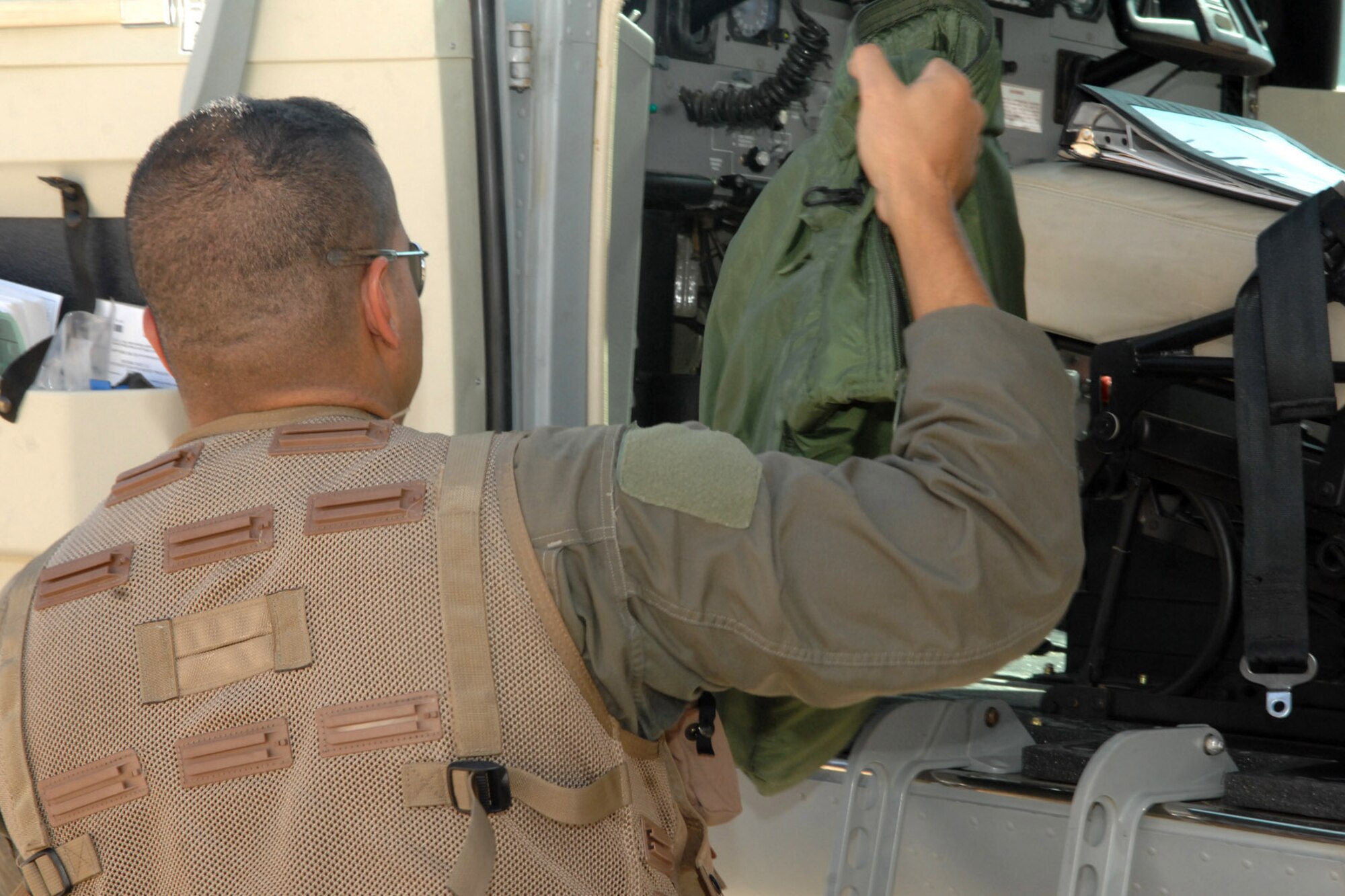 KIRKUK REGIONAL AIR BASE, Iraq -- Second Lt. Hassan, Iraqi air force student pilot, retrieves his flight bag after accomplishing his final check ride as well as the 3,000th flying training hour here Sept 23.  Lt. Col. Scott Voskovitch, 52nd Expeditionary Flying Training Squadron instructor pilot, sat in the instructor seat of the Cessna 208 Caravan on this monumental occasion.  "I feel so happy and so proud to have done this, because it's a big deal to be a pilot in Iraq," Hassan said. "We are surrounded by the best instructors and best (people) I have ever met. I appreciate the American team; they are helping all of Iraq to build the Iraqi air force." (U.S. Air Force photo/Senior Airman Randi Flaugh)
