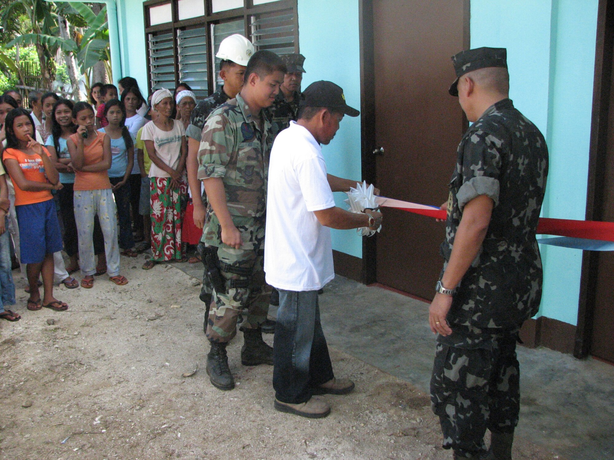 TAWI-TAWI, Philippine -- First Lt. Chin Hsu (second from left), 35th Civil Engineer Squadron engineer, takes part in a ribbon-cutting ceremony in Tawi-Tawi, a Philippine province, during Balikatan '08 March 1, 2008. The term Balikatan is a Tagalog word which means "shouldering the load together," and characterizes the philosophy and intent of the exercise. Both CE and PI engineers worked together to build the elementary school. (U.S. Air Force courtesy photo) 

