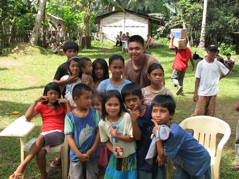 TAWI-TAWI, Philippine -- First Lt. Chin Hsu, 35th Civil Engineer Squadron engineer, poses with children in Tawi-Tawi, a Philippine province, during Balakatan '08 Feb. 29, 2008. Lieutenant Hsu led a team of Misawa engineers who worked with PI engineers to renovate an elementary school in Tawi-Tawi. This part of the exercise focuses on humanitarian and civic assistance. (U.S. Air Force courtesy photo) 

