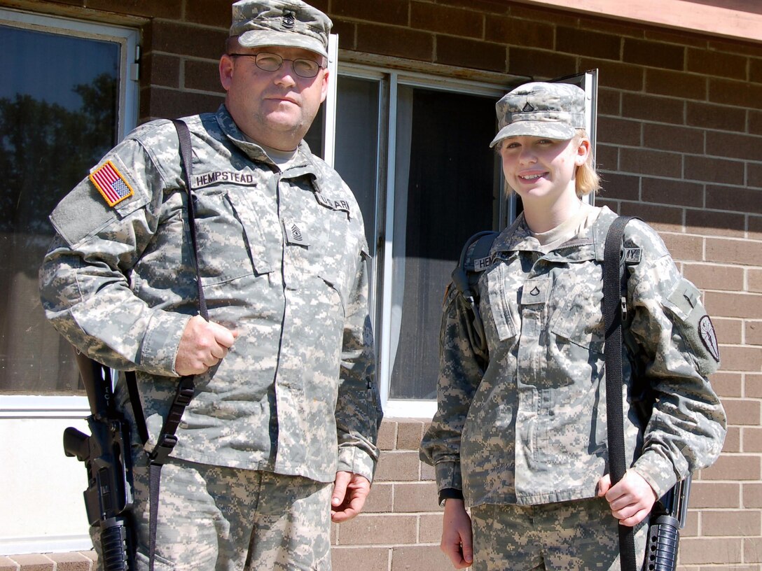 First Sgt. Bob Hempstead, 1313th Engineer Company, and his daughter Pfc. Crystal Hempstead, a light-wheel vehicle mechanic for the 1313th, will deploy together early next year.  Their unit is currently at Muscatatuck Urban Training Center on Camp Atterbury, Ind., conducting pre-mobilization training. U.S. Army photo by Spc. Elizabeth Gorenc