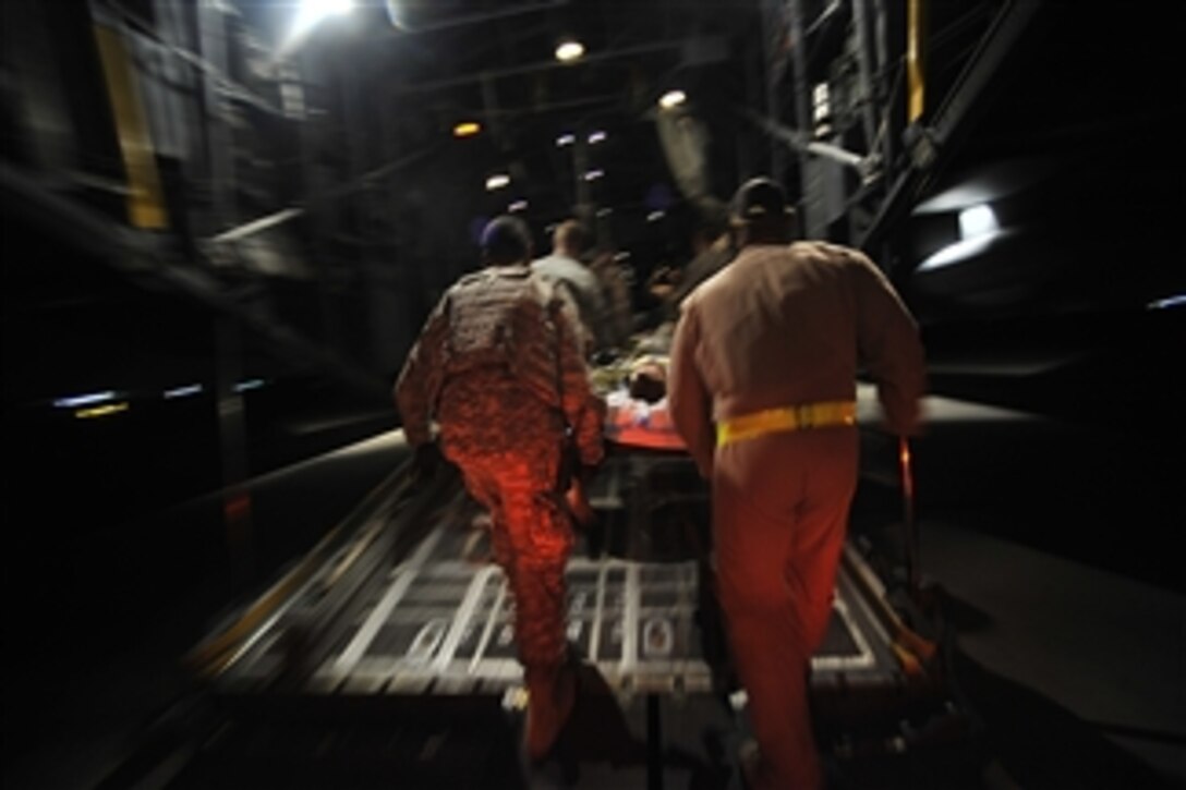 Patients from a forward operating base board a 777th Expeditionary Airlift Squadron C-130 Hercules aircraft during a Bandage Mission in Mosul, Iraq, on Sept. 23, 2008.  Bandage Missions travel to different forward operating bases throughout Iraq and pick up patients and transport them to the Air Force Theater Hospital in Joint Base Balad, Iraq.  