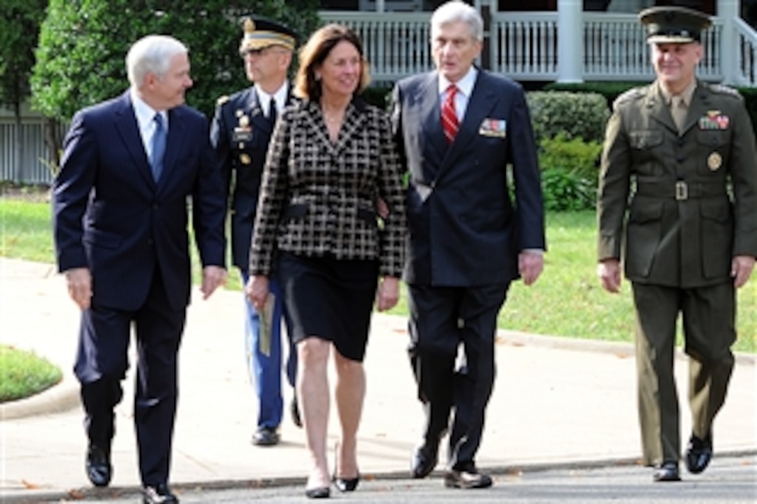 Defense Secretary Robert Gates, far left, and Vice Chairman of the Joint Chiefs of Staff U.S. Marine Gen. James E, Cartwright, far right, walk with U.S. Sen. John Warner, center, and his wife, Jeannie, during a military parade in honor of Warner's retirement at Whipple Field, Ft. Myer, Va., Sept. 24, 2008.  