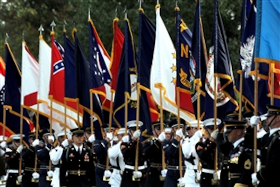 A joint color guard carries the flags from all 50 states during a military parade to honor retiring U.S. Sens. John Warner and Duncan Hunter on Whipple Field, Fort Myer, Va., Sept. 24, 2008. 