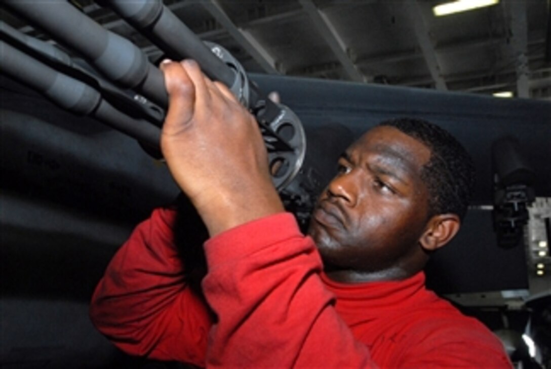 U.S. Navy Airman Anthony Chatfield reassembles the final piece of a gun turret removed from an F/A-18E Super Hornet aircraft assigned to Strike Fighter Squadron 115 in the hangar bay of the aircraft carrier USS Ronald Reagan (CVN 76) while underway in the Gulf of Oman on Sept. 19, 2008.  The Ronald Reagan is currently deployed to the U.S. 5th Fleet area of responsibility.  