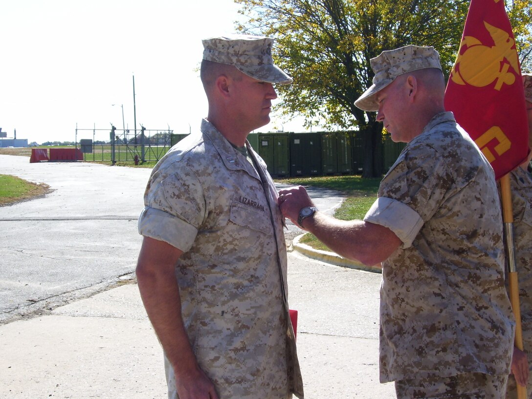 Lt. Col. Rob Roberson, Commanding Officer, 3rd Battalion, 14th Marines, pins the Bronze Star on Capt. Joseph Lizarraga, Inspector/Instructor, Battery G, 3rd Battalion, 14th Marines.  Lizarraga received the Bronze Star Oct. 20, for his involvement in Battery G’s recent deployment to Iraq. During that time, Lizarraga lead 80 Marines from the Trenton, N.J., area in detainee operations for a regional detention facility.