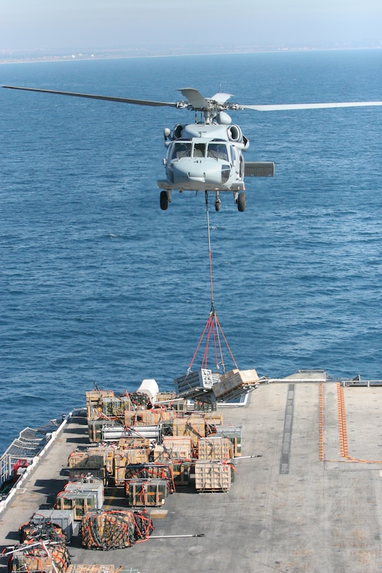 Helicopter Sea Combat Squadron 21 began doubling up on their VERTREP operations because of the fog on the previous day. HSC 21 is lifting these munistions off of the Flight Deck of the USS Tarawa and dropping off on Camp Pendleton's Red Beach.