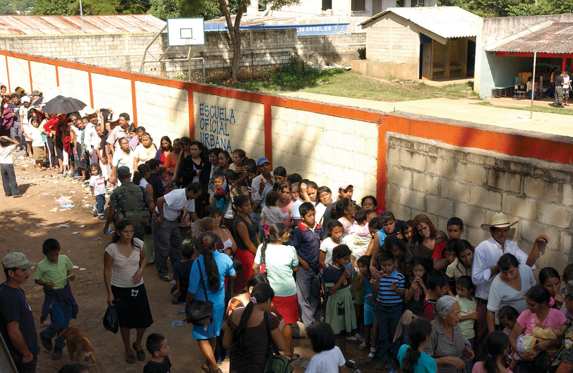 Hundreds of Guatemalan citizens line the street at a school in Santa Maria de Ixhuatan waiting to see medical providers from the 163d Medical Group. Thirty-one members of the group traveled to Guatemala to provide medical care for more than 5,700 people during a U.S. Air Forces South-sponsored Medical Readiness Training Exercise held Aug. 16 - 31.  (U.S. Air Force photo by Capt Al Bosco, 163RW/PA)