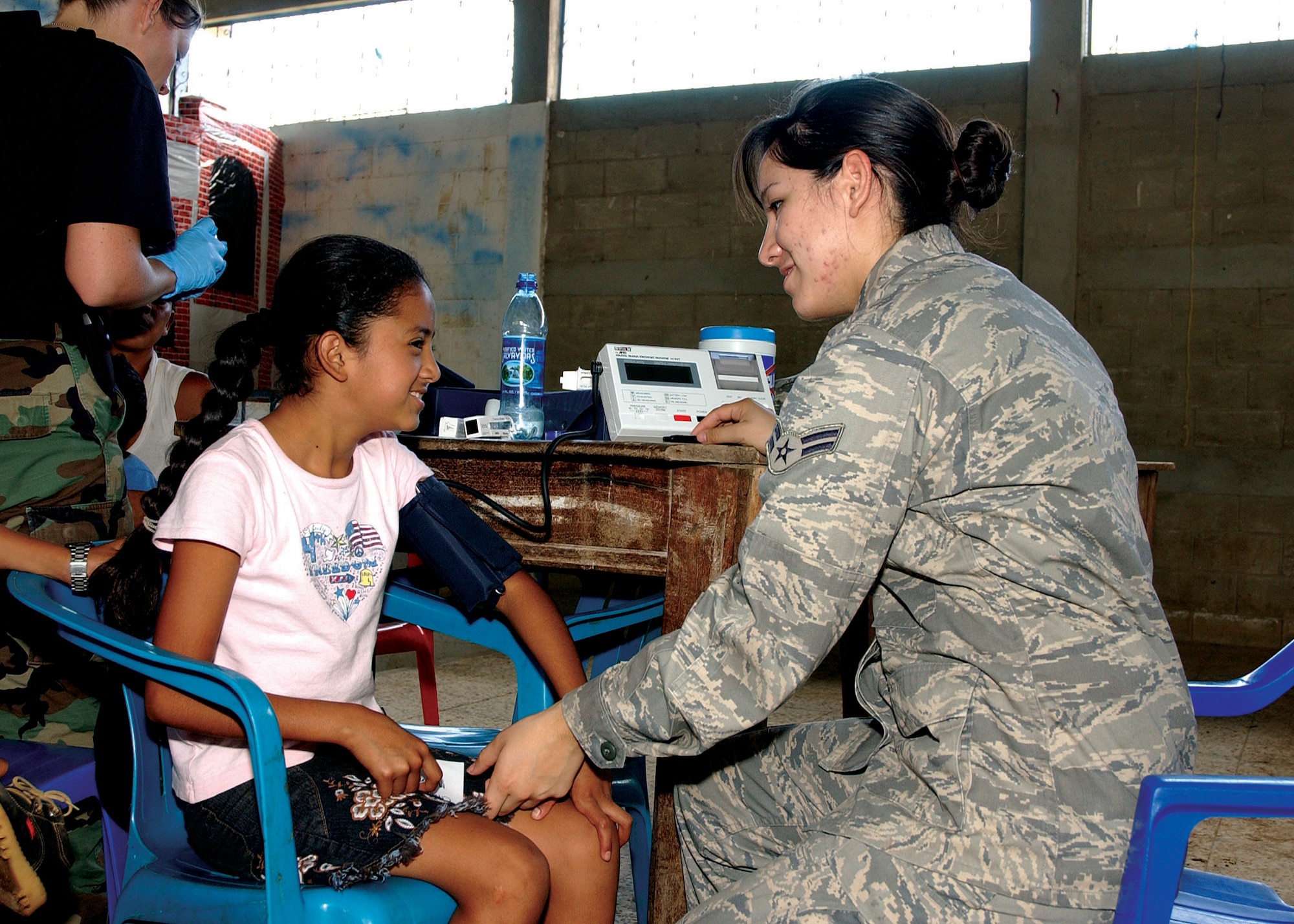 Airman 1st Class Jasmine Diaz, 163d Medical Group medical technician, checks a Guatemalan girl's blood pressure at a school in Santa Rosa. More than 5,700 Guatemalan citizens from three of Santa Rosa's poorest communities flocked to see members of the 163d medical group who traveled to Guatemala Aug. 16-30 to provide medical care. (U.S. Air Force photo by Capt Al Bosco, 163RW/PA)