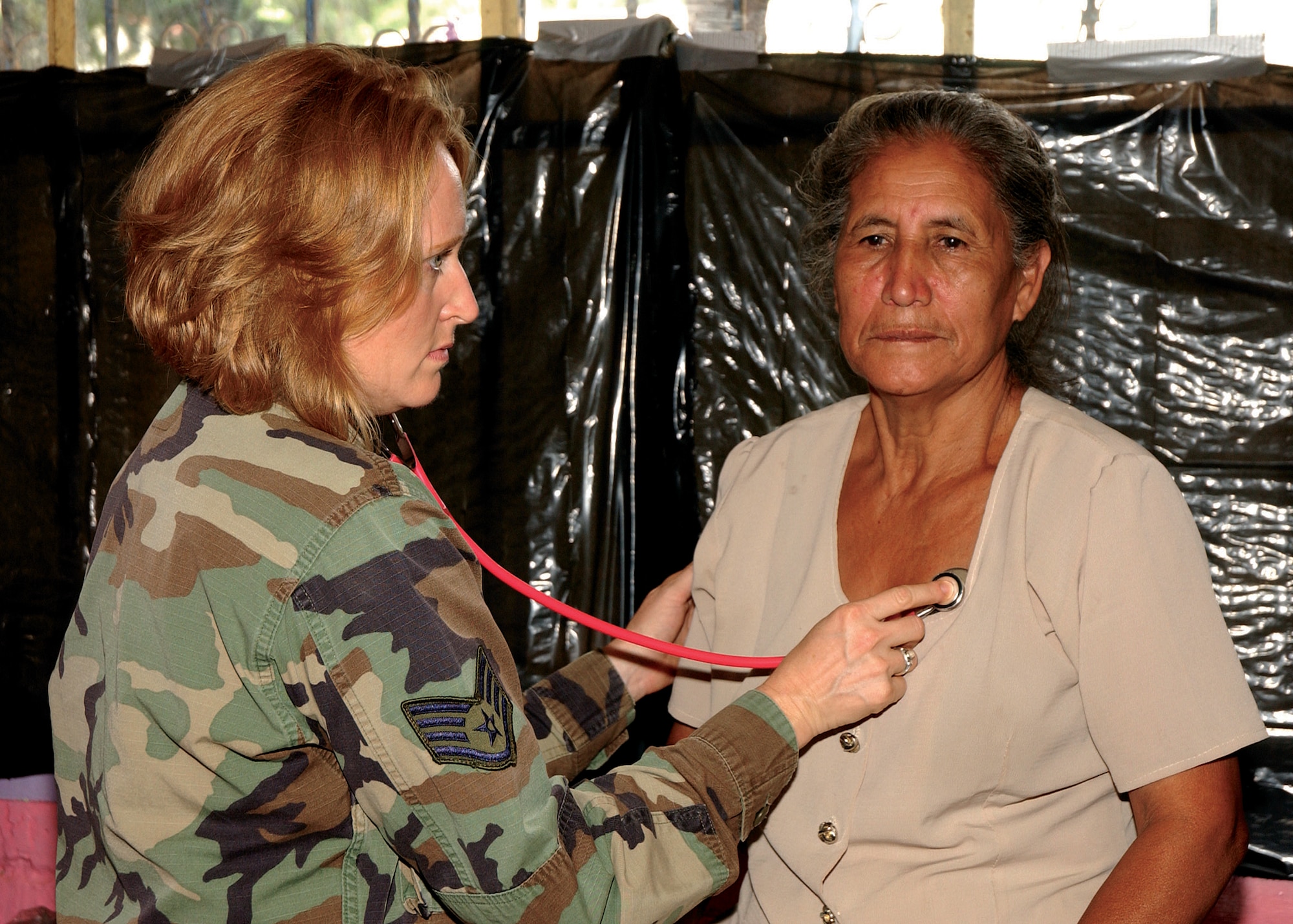 Staff Sgt. Paige Whitworth, 163d Medical Group medical technician, listens to a Guatemalan woman's heart. Sergeant Whitworth and 30 other members of the 163d Medical Group traveled to Guatemala Aug. 16-30 where they provided treatment for more than 5,700 people while visitng three of Santa Rosa's poorest communities. (U.S. Air Force photo by Capt Al Bosco, 163RW/PA)