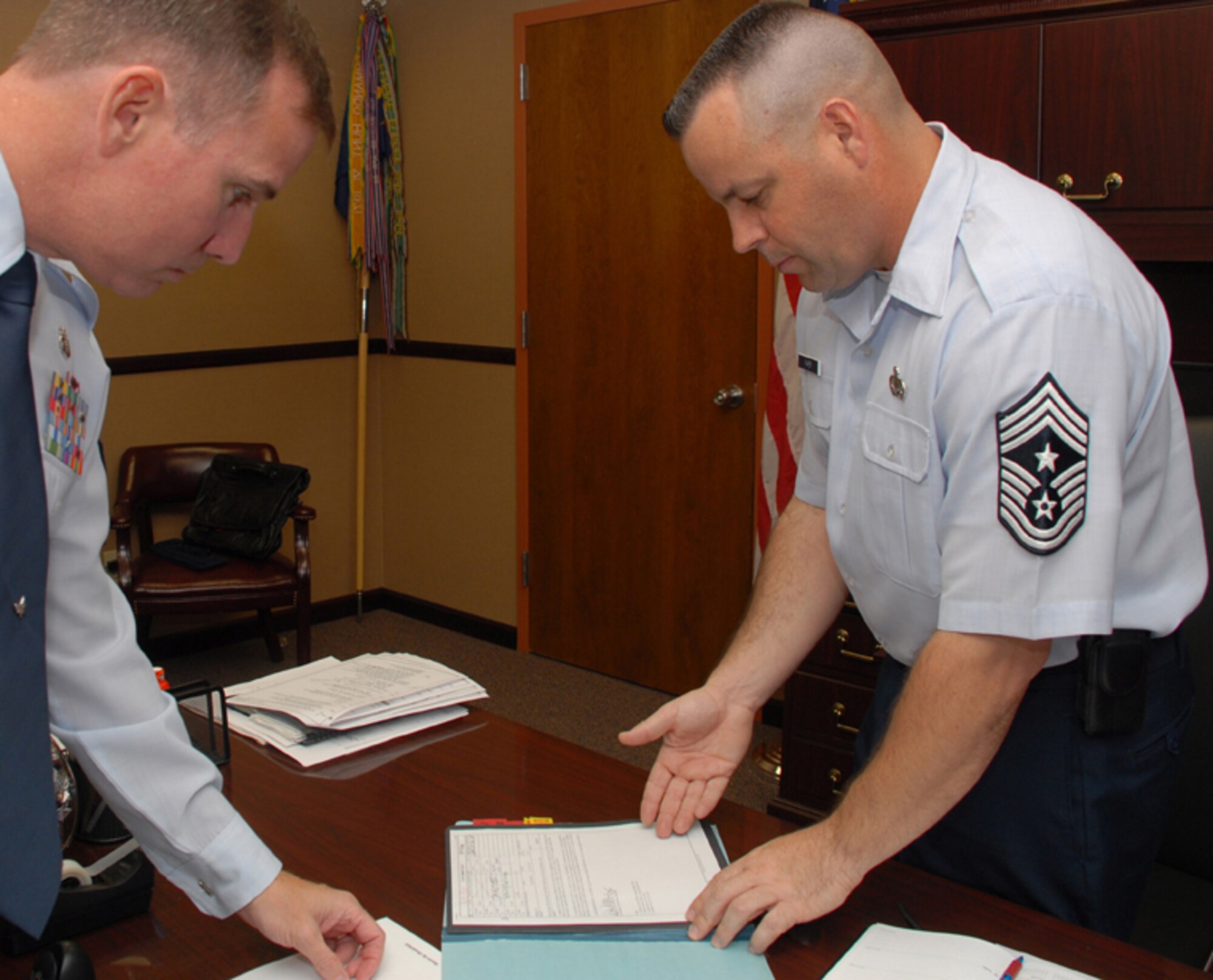 Chief Master Sgt. Randall Raper, 56th Fighter Wing command chief, discusses Luke issues with Chief Master Sgt. Richard Robinson, 56th Medical Group superintendent and former acting command chief.