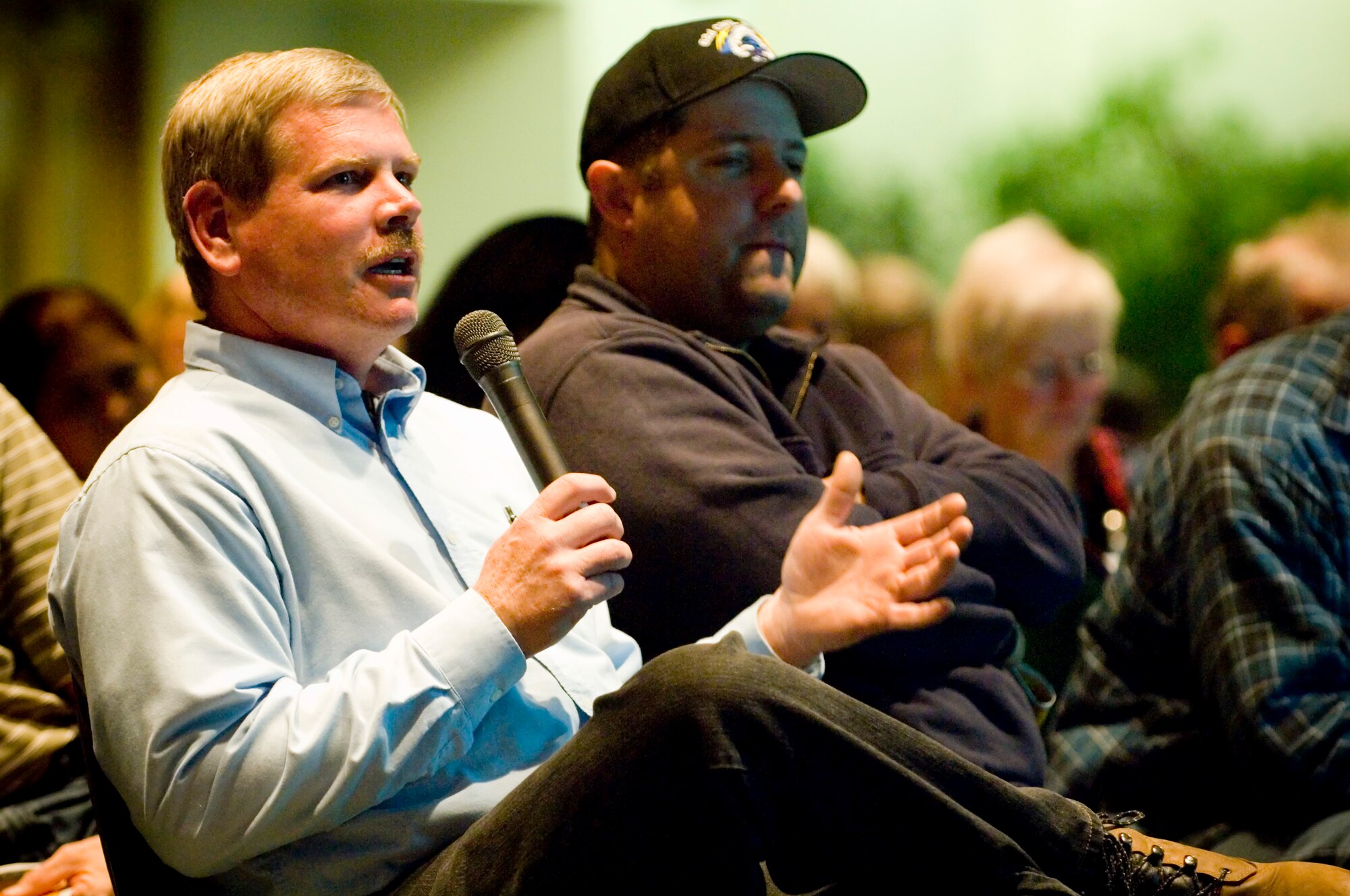Timothy Downs, 62nd Civil Engineer Squadron, left, asks Col. Shane Hershman, Air Mobility Command Joint Base Lewis-McChord initiative director, a question concerning prescriptions at McChord’s pharmacy.
