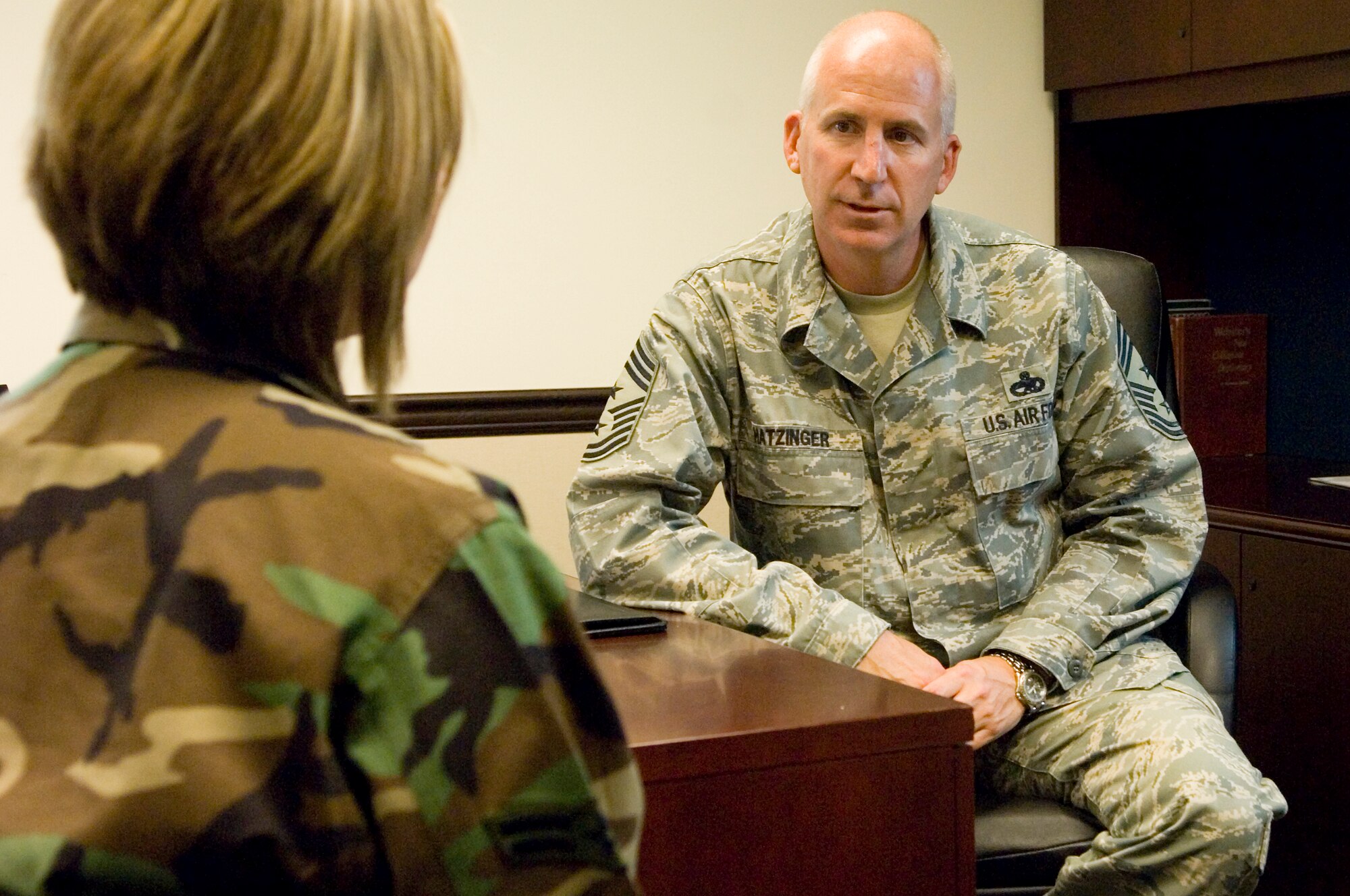 The 62nd Airlift Wing’s new command chief, Chief Master Sgt. Cary Hatzinger,
speaks with an Airman about readiness and the upcoming Ability To Survive
and Operate Training. With 22 years of Air Force experience, Chief Hatzinger
maintains a critical link between the 62nd Airlift Wing commander and enlisted
Airmen of the wing. The command chief also ensures the commander's
policies are known and understood by the 2,900 enlisted Airmen assigned
to the wing. (U.S. Air Force photo/Abner Guzman)