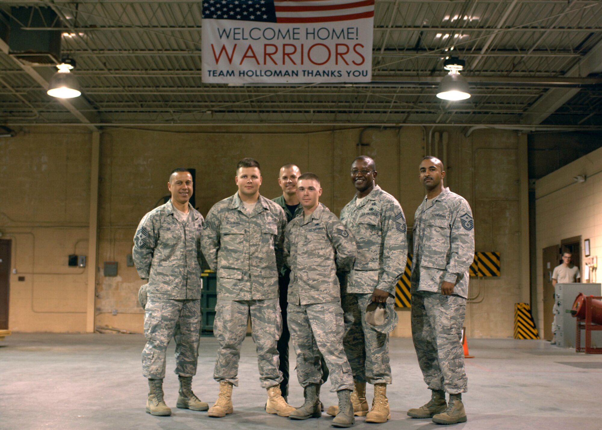 Returning deployer Staff Sgt. Joshua Behrmann, 49th Communications Squadron, poses for a group photo with members of the 49th Communications Squadron who welcomed him home from his four-month deployment. Sergeant Behrmann worked force protection during his deployment to Kirkuk, Iraq. (U.S. Air Force photo/Airman 1st Class Veronica Salgado)