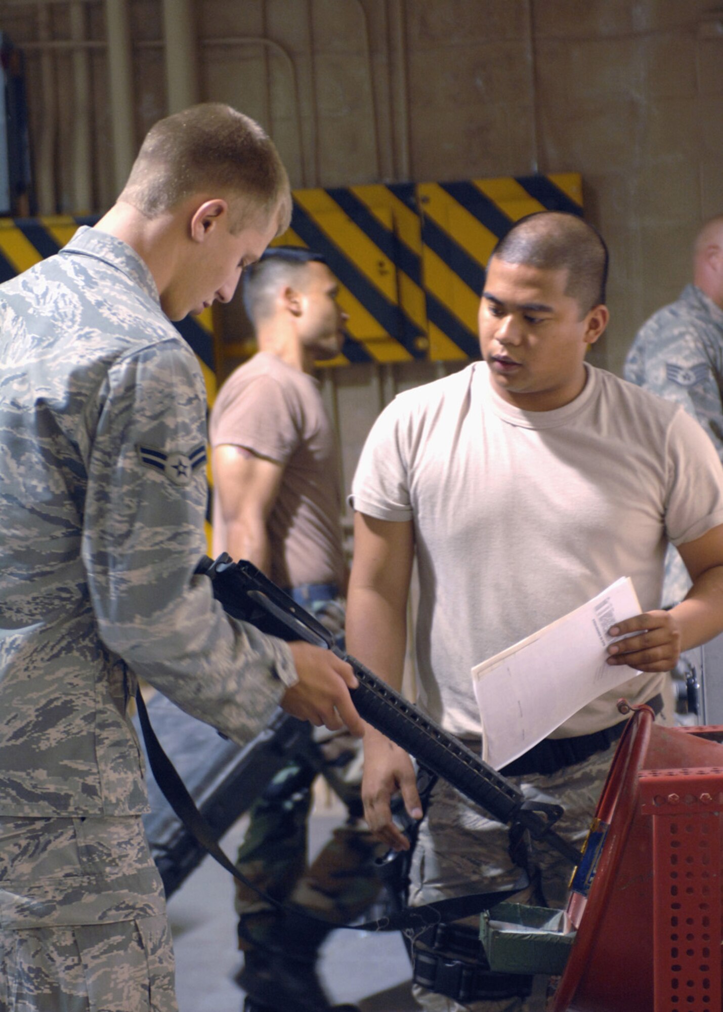 Airman 1st Class Kyle Deconnick, 49th Materiel Maintenance Squadron, clears his M-16 at the weapons vault by Senior Airman Alfie Agmata, 49th Logistics Readiness Squadron, September 23. Airman Deconnick recently returned to Holloman Air Force Base, N.M. after a four-month deplyment to Kirkuk, Iraq. (U.S. Air Force photo/Airman 1st Class Veronica Salgado) 