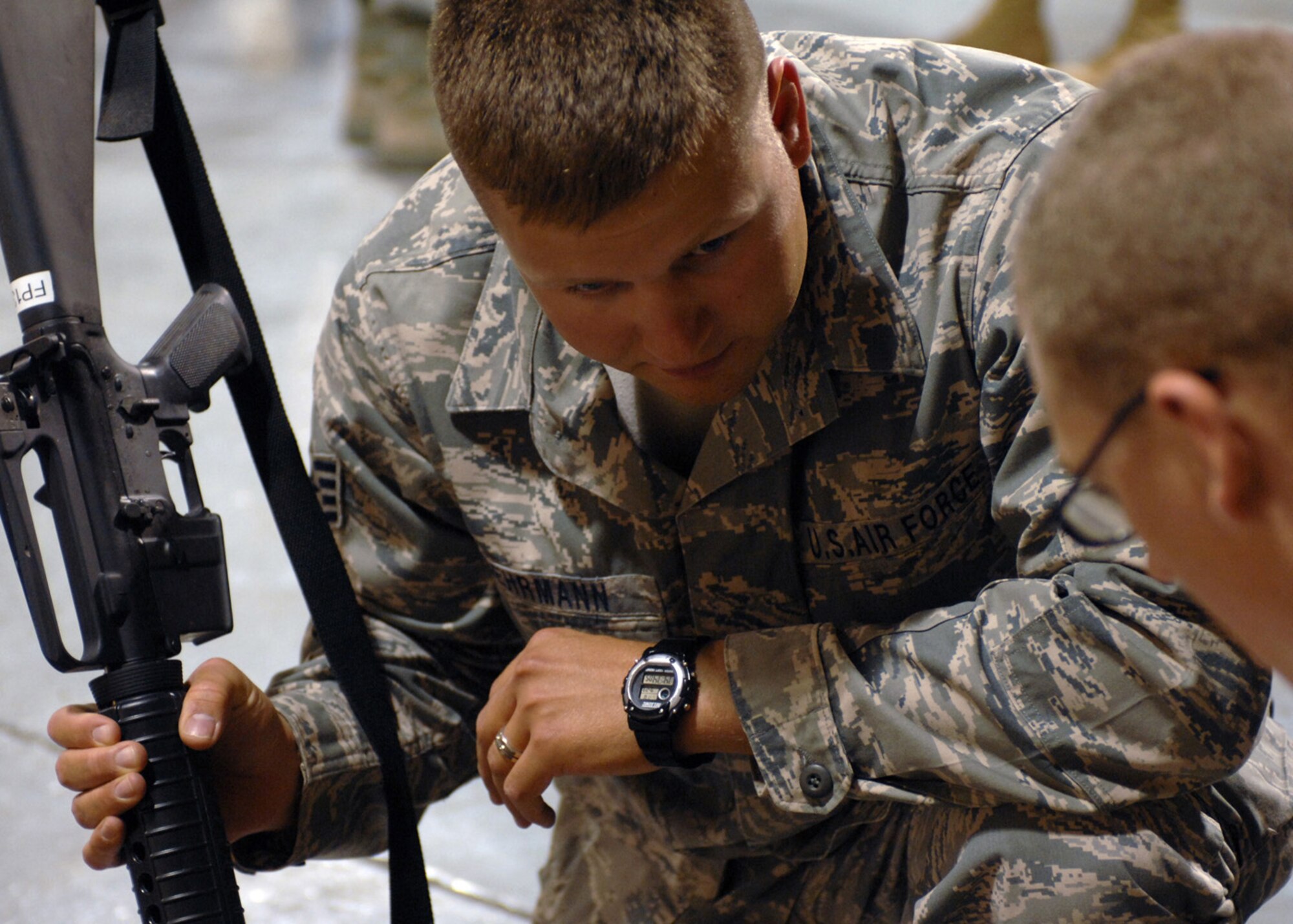 Staff Sgt. Joshua Behrmann from the 49th Communications Squadron gets his weapon checked by Airman 1st Class Kyle Saringer, 49th Logistics Readiness Squadron, in the weapons vault at Holloman Air Force Base, N.M., September 23. Sergeant Behrmann was one of four Airman who just returned home from a four-month deployment to Kirkuk, Iraq. (Photo by U.S. Air Force photo/Airman 1st Class Veronica Salgado)