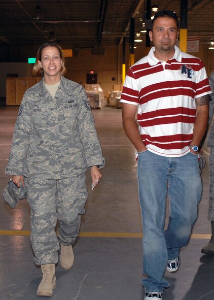 Tech. Sgt. April Brown, 49th Operation Support Squadron, departs with Master Sgt. Paul Connelly, also from the 49 OSS, in the weapons vault at Holloman Air Force Base, N.M., September 16. Sergeant Brown, who works at White Sands Missile Range, just returned home from a six-month deployment to Kirkuk, Iraq. (U.S. Air Force photo/Veronica Salgado)