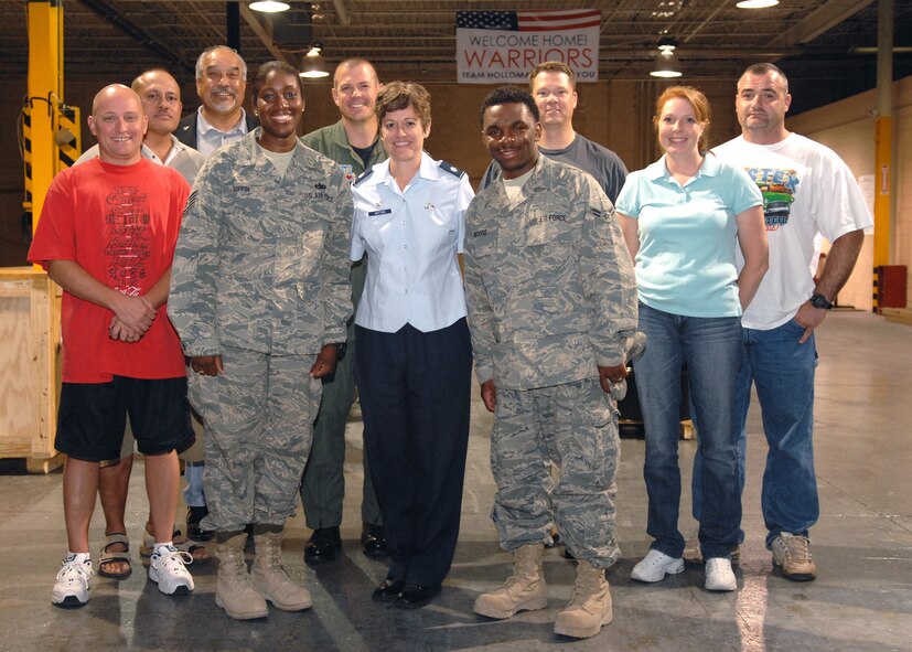 Returning deployers from the 49th Logistics Readiness Squadron pose for a group photo at the weapons vault at Holloman Air Force Base, N.M., September 15. Col. Michael McGee, 49th Fighter Wing vice commander, and commander of the 49 LRS Lt. Col. Melissa Batton, are two of many who welcomed the warriors home. (U.S. Air Force photo/Airman 1st Class Veronica Salgado)