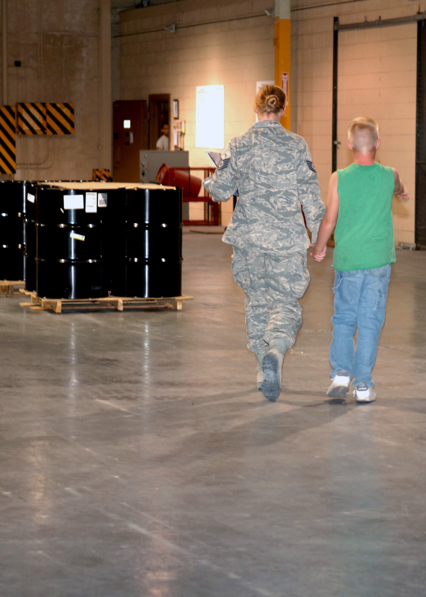 Tech Sgt. Valerie Rowe, 49th Materiel Maintenance Group, walks with ten year old son, Ethan Rowe in the weapons vault at Holloman Air Force Base, N.M., September 15. While deployed to Balad, Iraq, she worked as a traffic management specialist. (U.S. Air Force photo/Airman 1st Class Veronica Salgado) 
