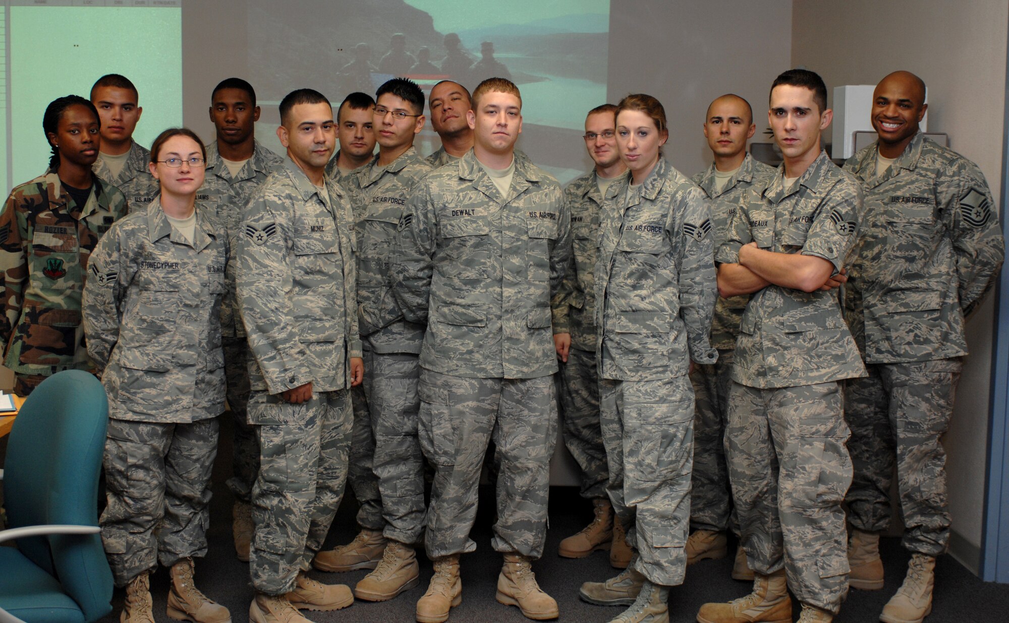 Fourteen members from the 49th Logistic Readiness Squadron pose for a photo at Holloman Air Force Base, N.M., after returning home from a deployment. Twelve of the Airmen were gone for eight months on a deployment to Kuwait, while two others were deployed to Iraq for five months. Col. Michael McGee, 49th Fighter Wing vice commander, and Chief Master Sgt. Jeffrey Cui, 49 FW command chief, both welcomed the warriors home. (U.S. Air Force photo/Airman Sondra M. Escutia)