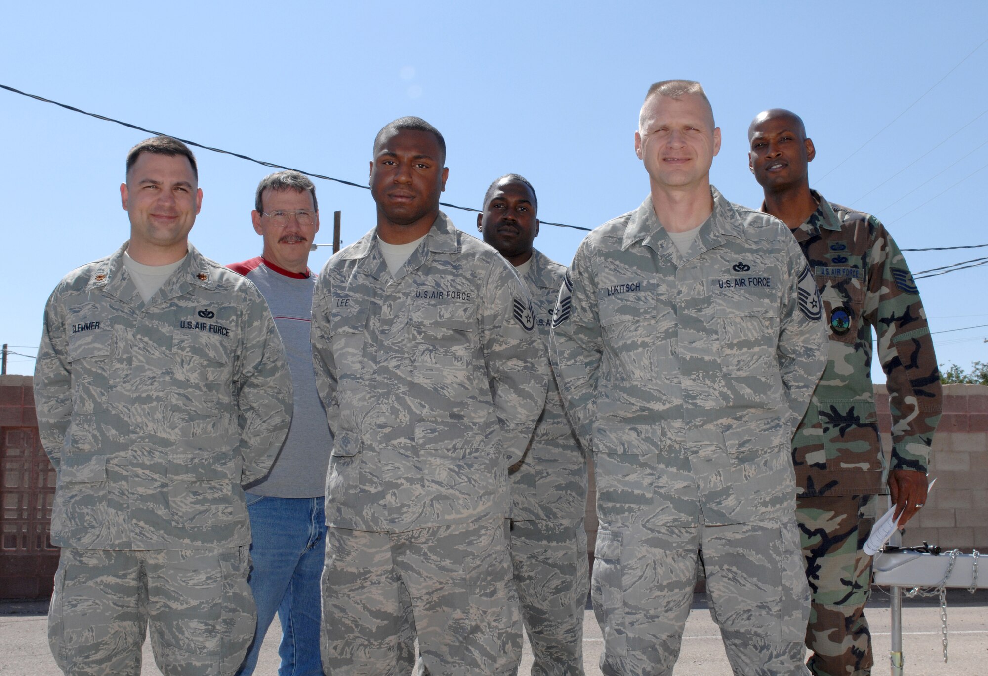Staff Sgt. Eric Lee, 49th Civil Engineer Squadron, poses for a group photo with 49 CES members who welcomed him home from a five month deployment to Kirkuk Air Base, Iraq at Holloman Air Force Base, N.M., September 23. From left to right: Maj. Nathan Clemmer, Mr. Ronnie Elswick, HVAC shop chief, Staff Sgt. Eric Lee, Staff Sgt. James Kinslow, Senior Master Sgt. Edward Lukitsch and Tech. Sgt. Corey Faust, all from the 49 CES. (U.S. Air Force photo/Airman Sondra M. Escutia)