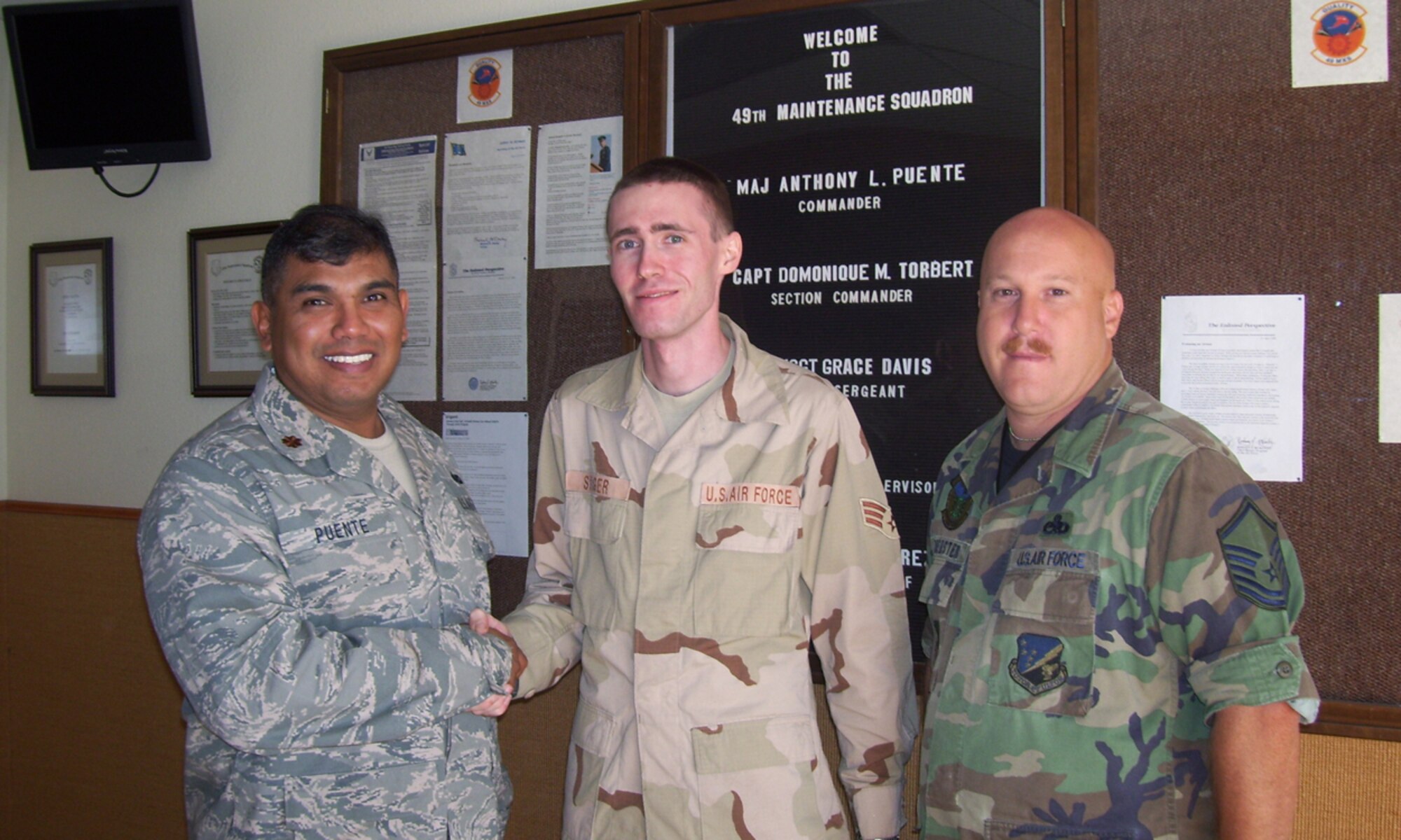 Maj. Anthony Puente, 49th Maintainence Squadron Commander, Senior Airman Jeffery Singer and Master Sgt.  Bruce Hoersten pose for a photo at Holloman Air Force Base, N.M., September 23. Airman Singer served on a 120 day deployment to Qatar. (Photo provided by Senior Master Sgt. Grace Davis)