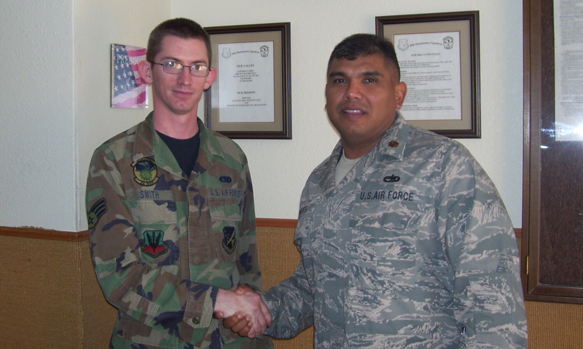 Maj. Anthony Puente, 49th Maintainence Squadron Commander, shakes Senior Airman Shaun Smith's hand at Holloman Air Force Base, N.M., September 23. Airman Smith served on a 120 day deployment to Qatar. (Photo provided by Senior Master Sgt. Grace Davis)