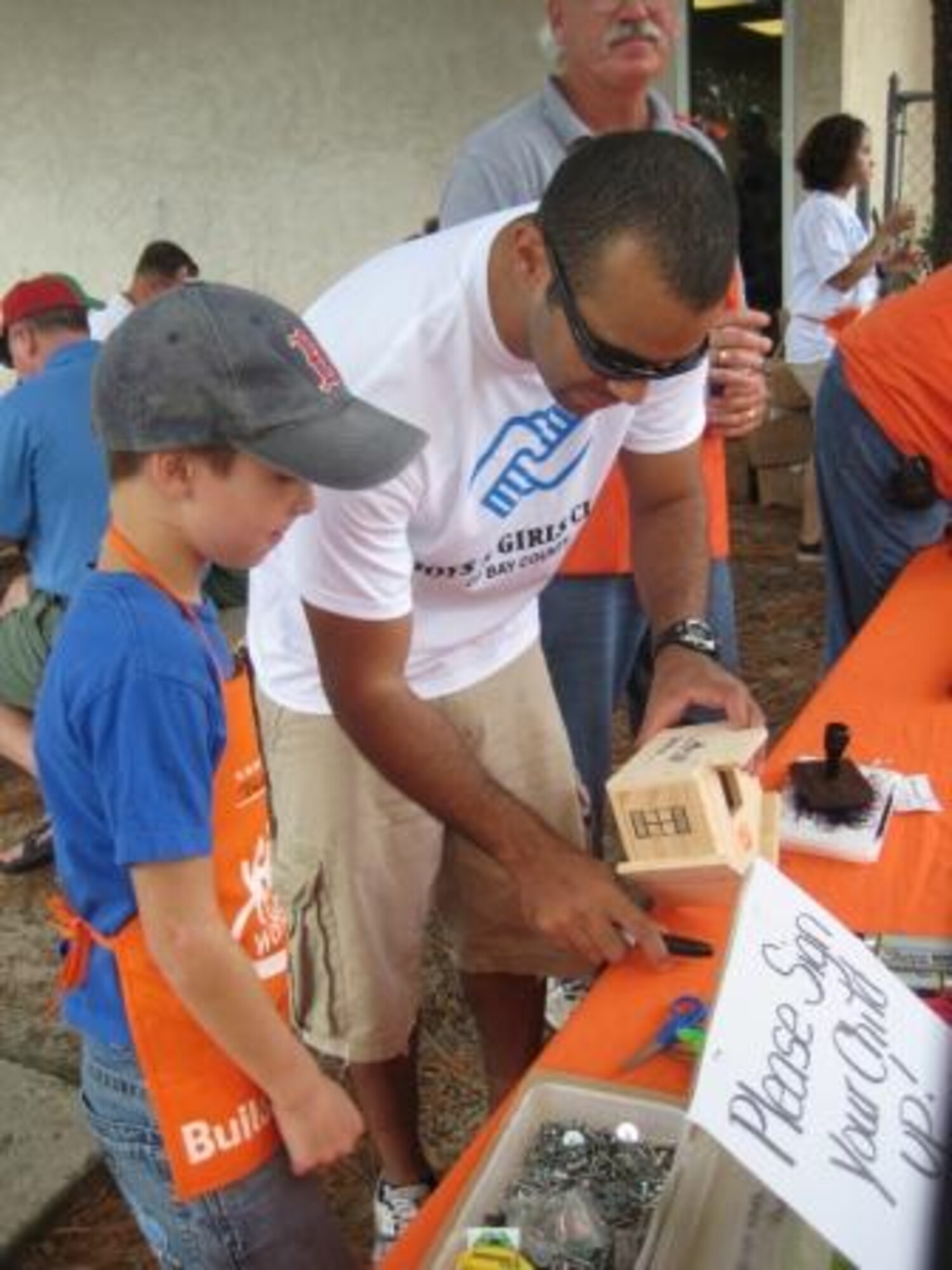 First Lieutenant Oscar Ramos, 325th Maintenance Squadron maintenance officer, and other members of the Tyndall Air Force Base Company Grade Officers Club volunteered at the Bays and Girls Club "Day for Kids" downtown Panama City Sept 22. Tyndall volunteers helped children complete Home Depot construction projects, which were meant to teach the satisfaction of starting and completing a job well done.  Over 600 families attended this year's event.  