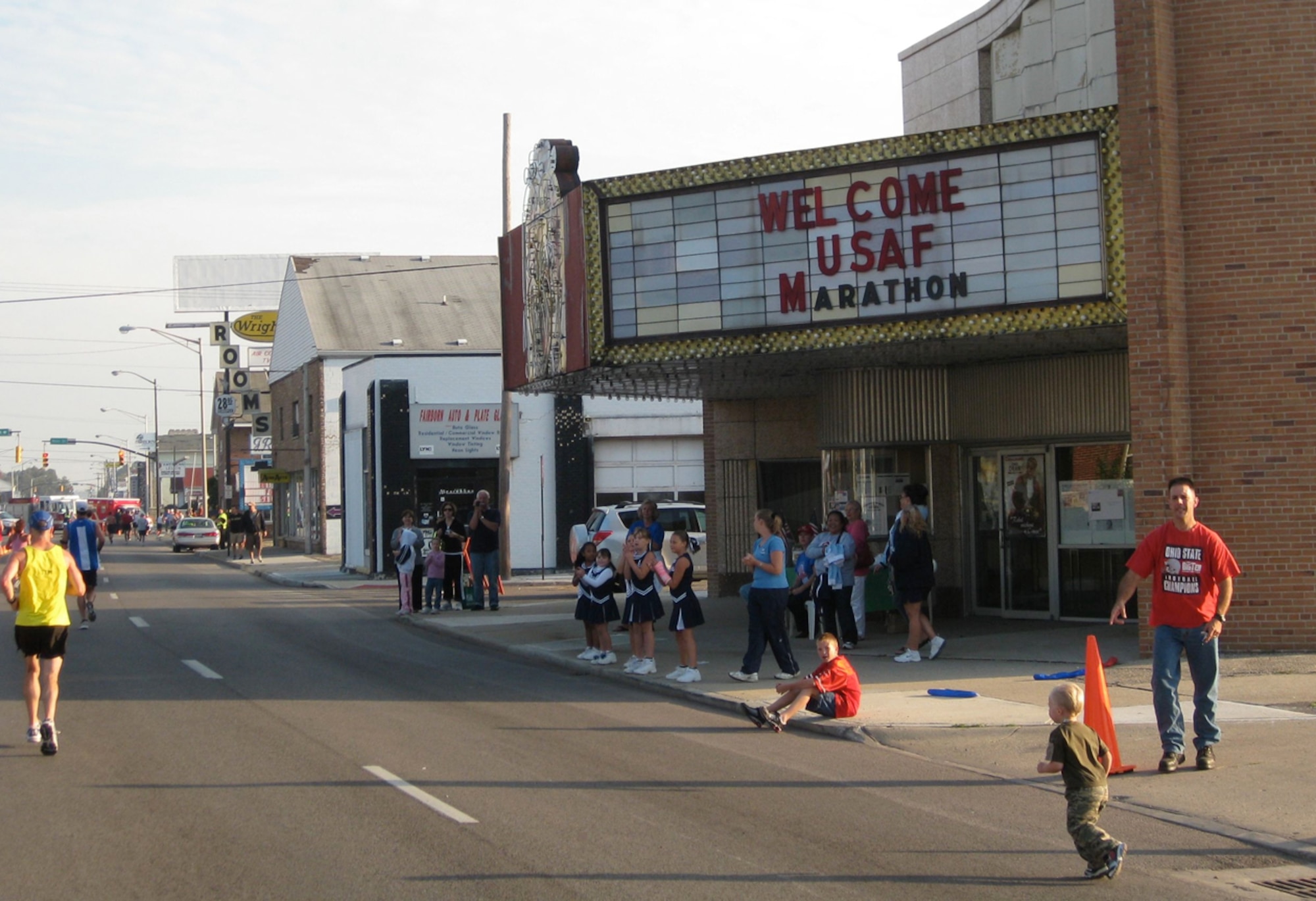 A youngster runs along the sidelines as runners pass by. The Air Force Marathon course took runners in and around Wright-Patterson AFB, Ohio.