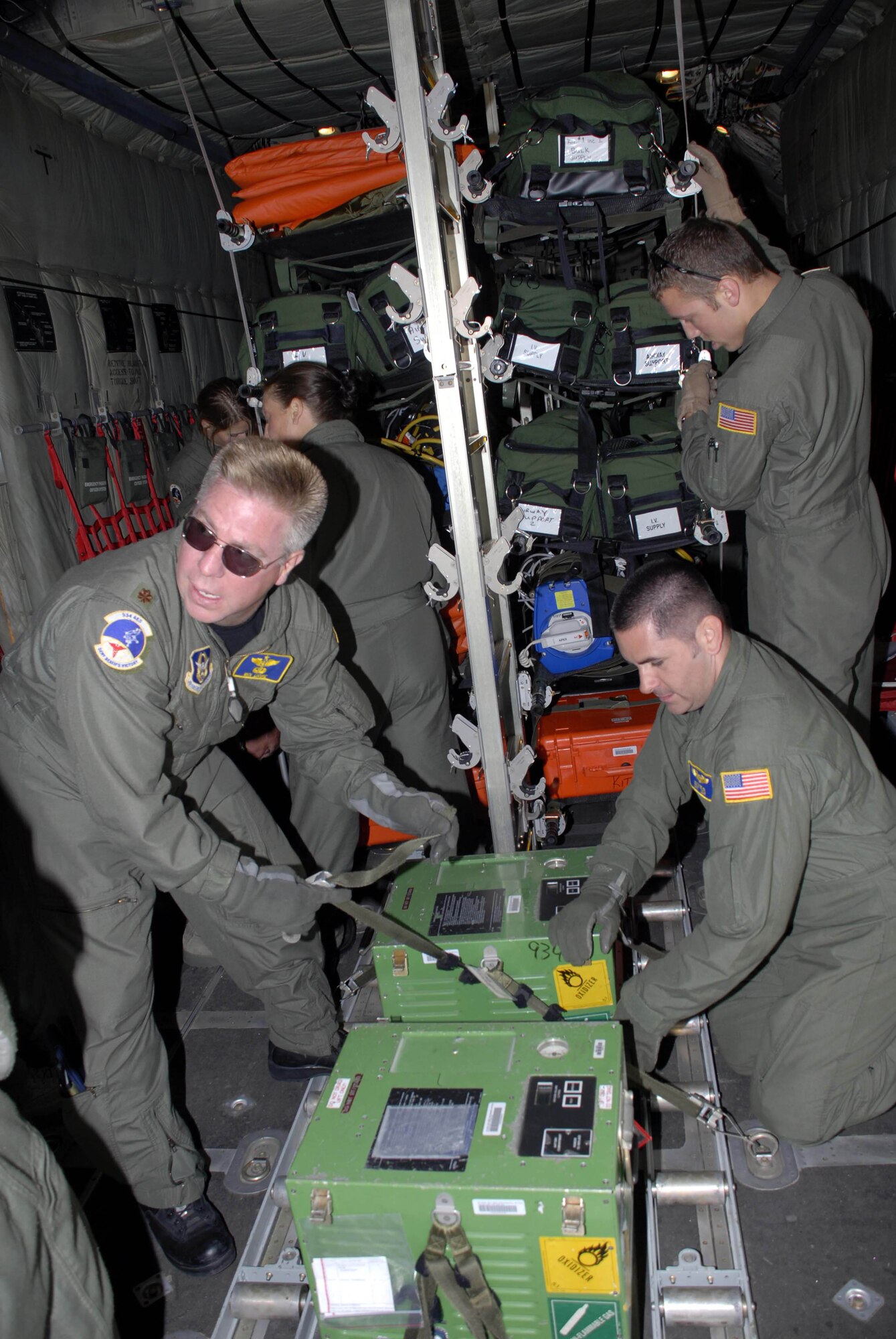 934th Aeromedical Evacuation Squadron members secure cargo and supplies aboard a C-130 before departing to support Hurricane Ike victims.