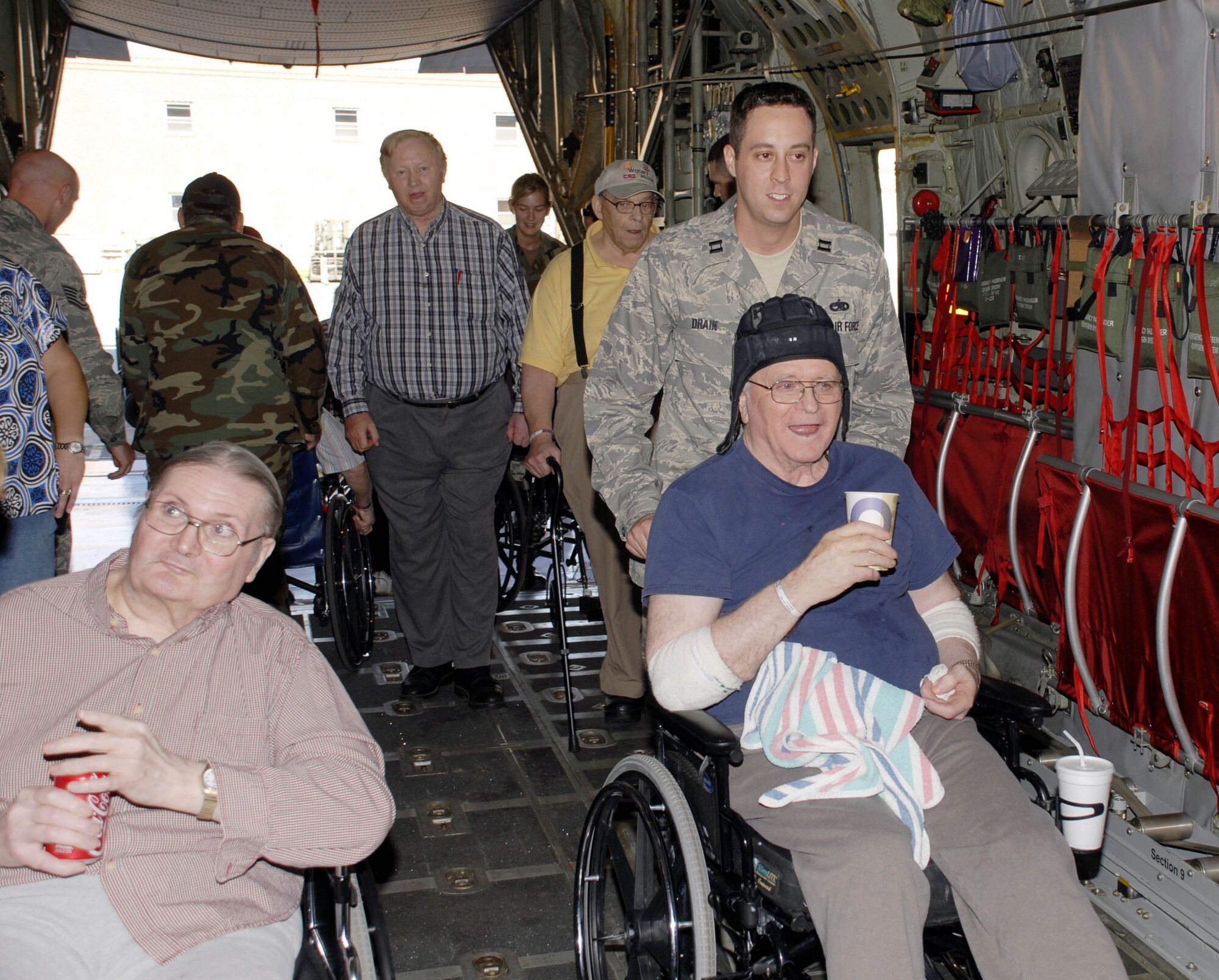 Capt. John Drain, 934th Maintenance Squadron shows veterans from the Minnesota Veterans Home around a 934th C-130.  Members of the 934th Airlift wing hosted the vets for an afternoon of  luch, conversation and tours. (Air Force photo/Master Sgt. Paul Zadach).